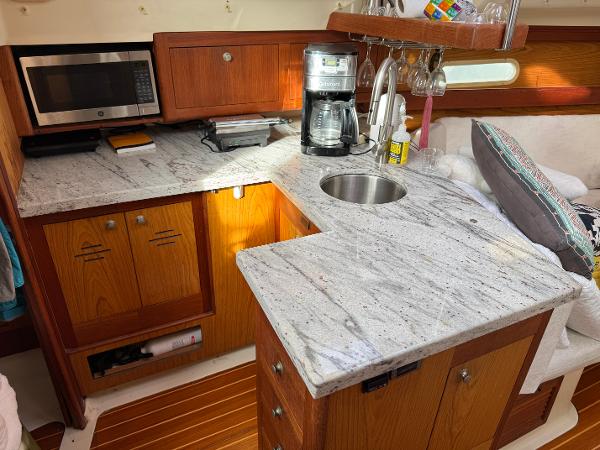 Hunter 340 yacht kitchen with granite countertops, microwave, and coffee maker, 2000 model.