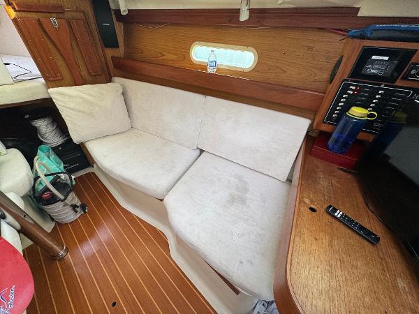 Interior of a 2000 Hunter 340 sailboat with a cozy seating area.