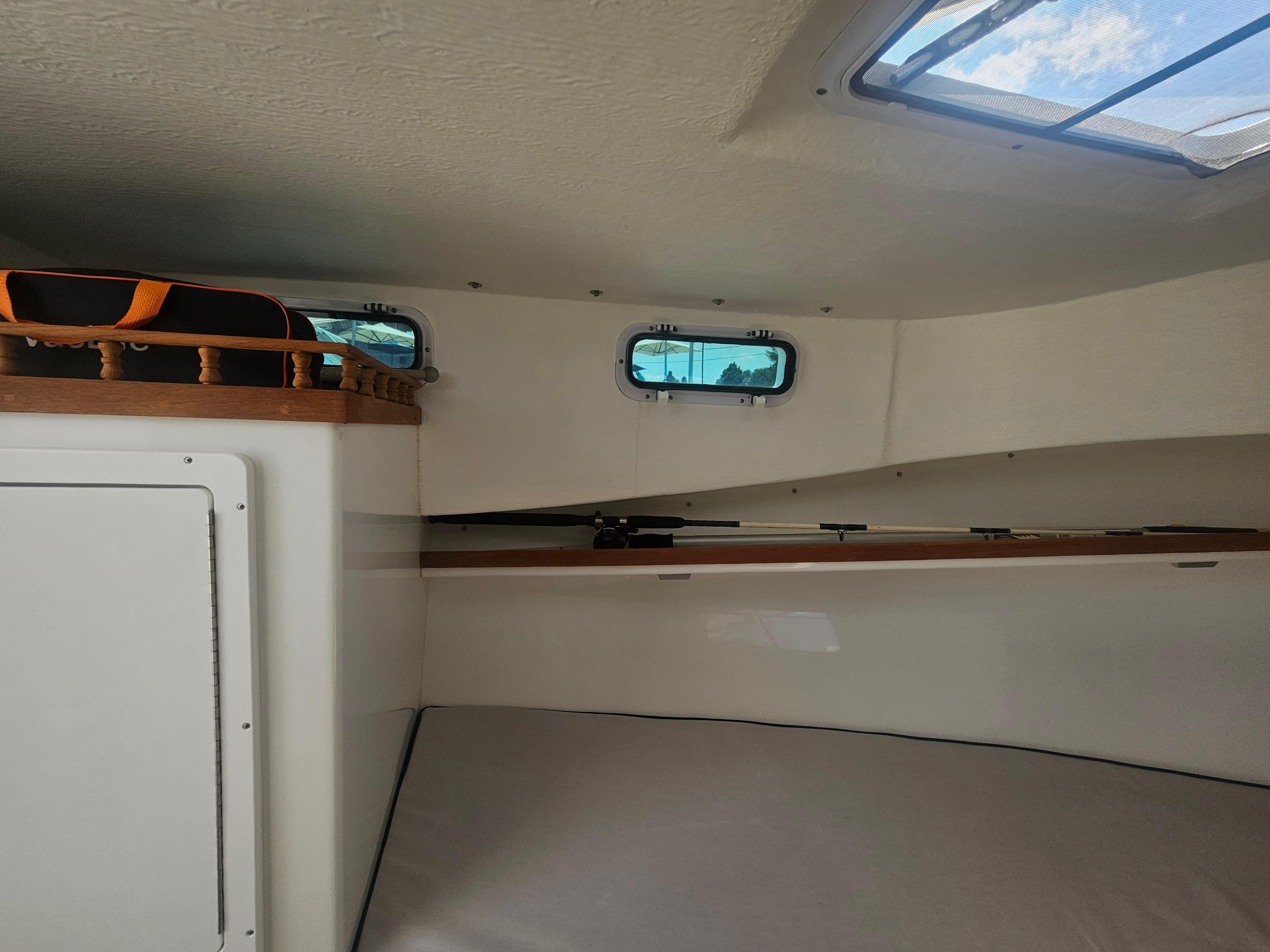 Interior cabin of 2019 Eastern 248 Explorer boat with skylight and storage.
