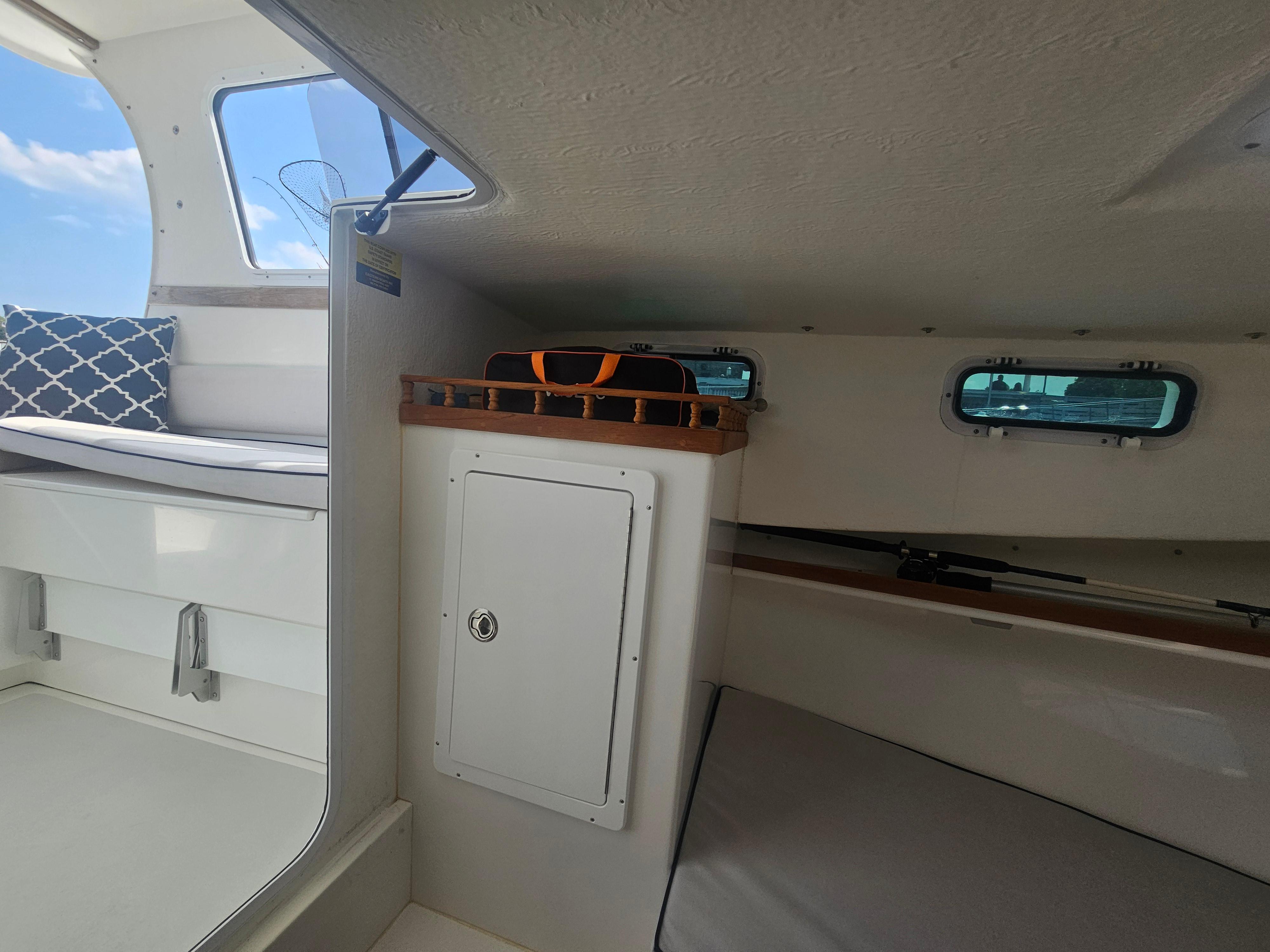 Interior of a 2019 Eastern 248 Explorer boat with seating and storage.