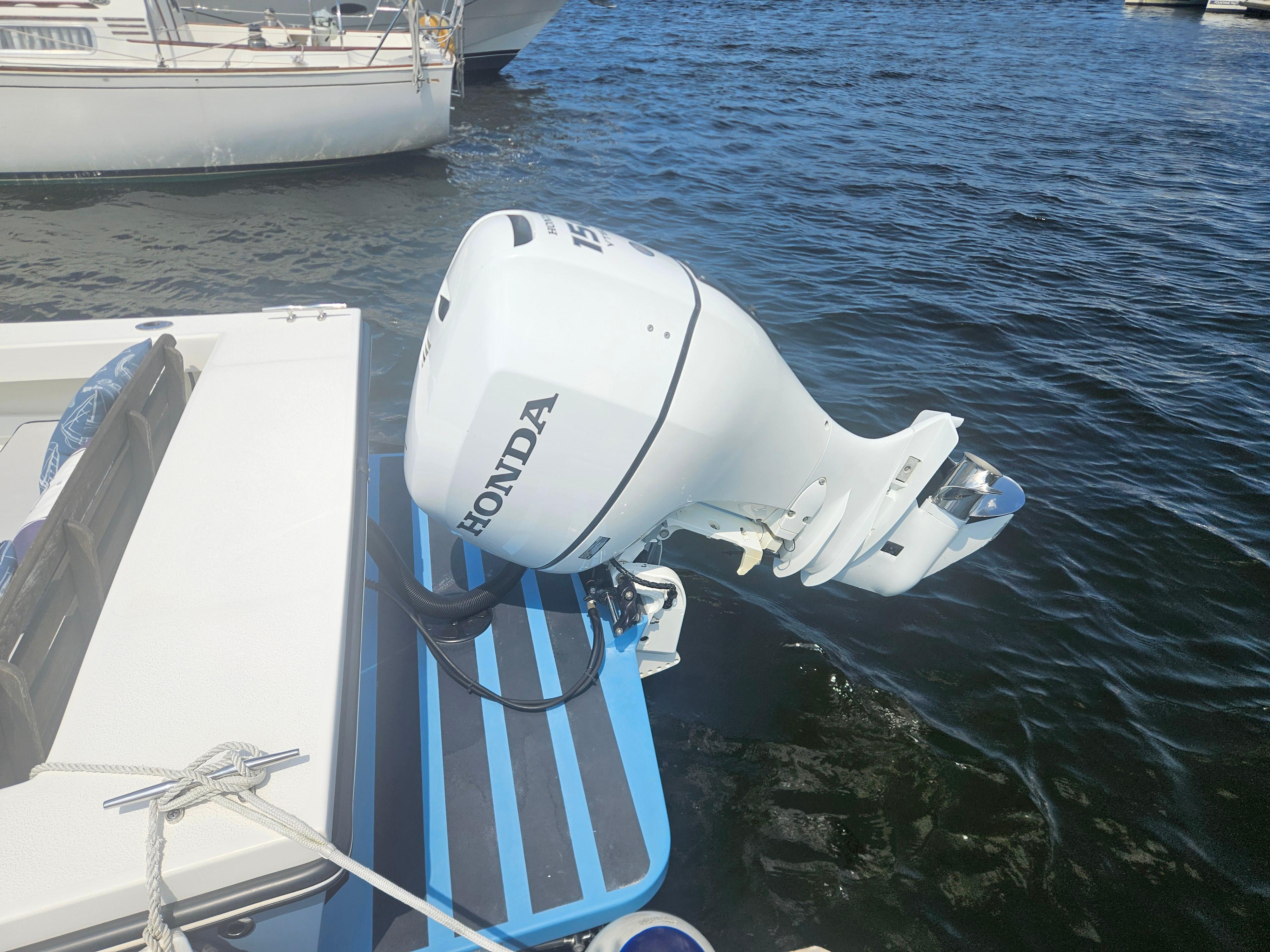 Outboard motor on 2019 Eastern 248 Explorer boat, docked on water.