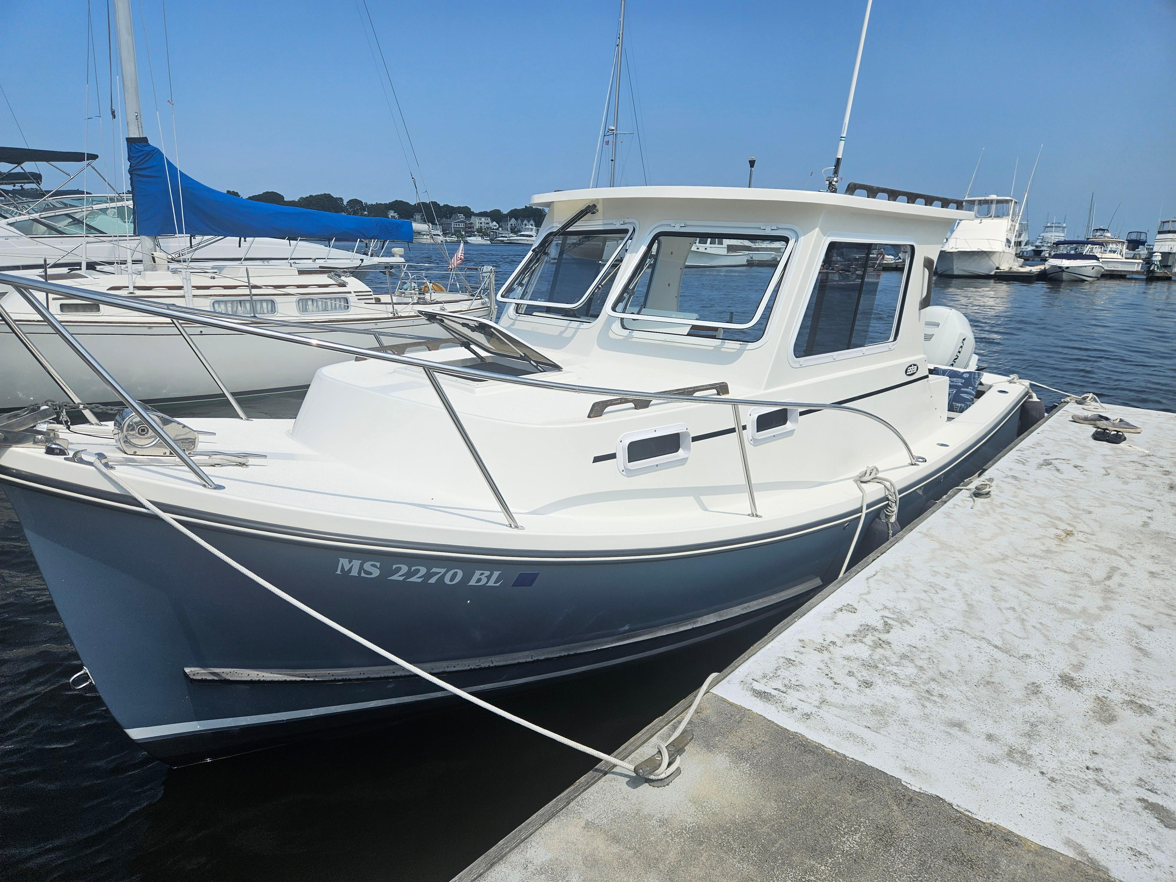2019 Eastern 248 Explorer boat docked at marina on a sunny day.