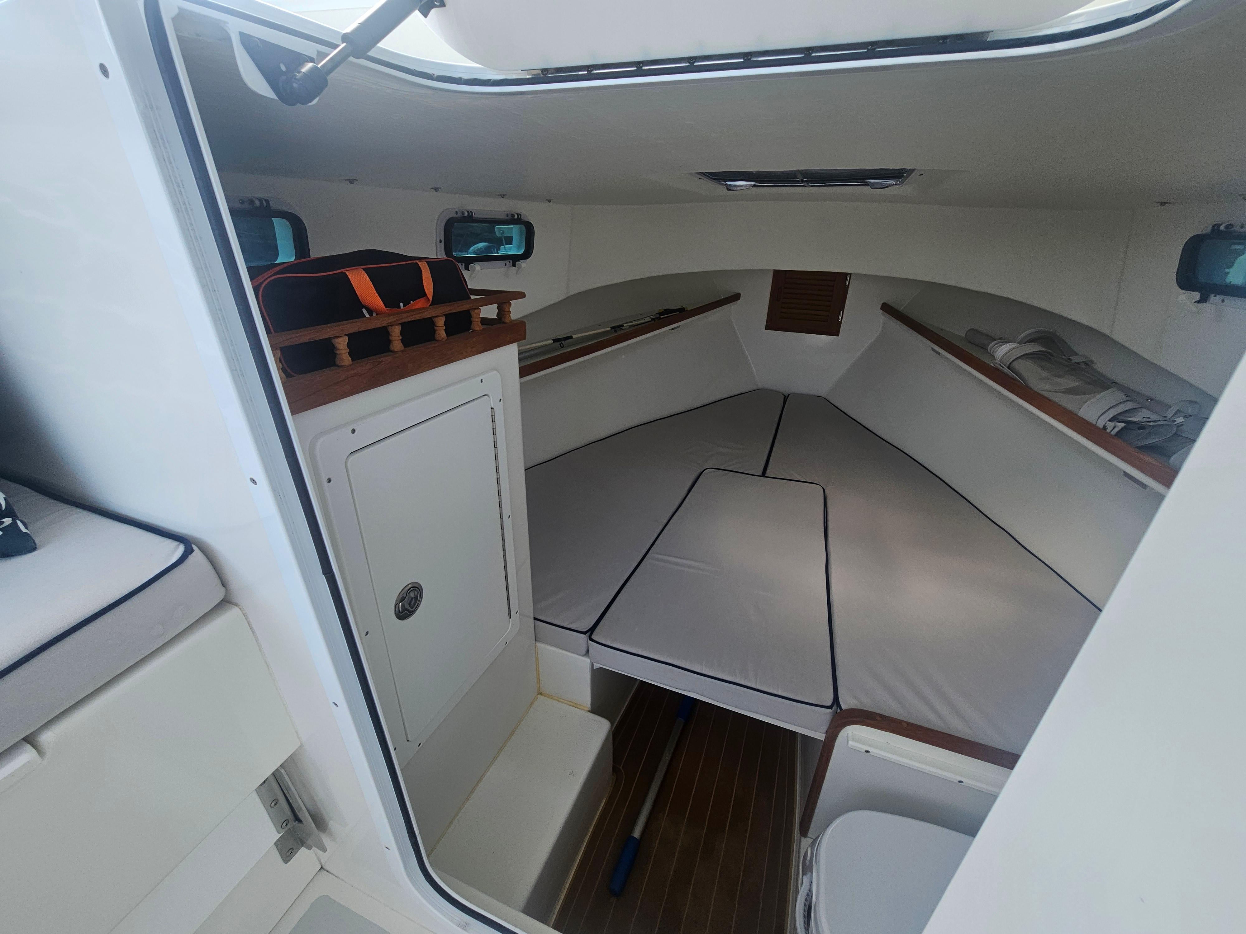 Interior cabin of 2019 Eastern 248 Explorer boat, featuring seating and storage.