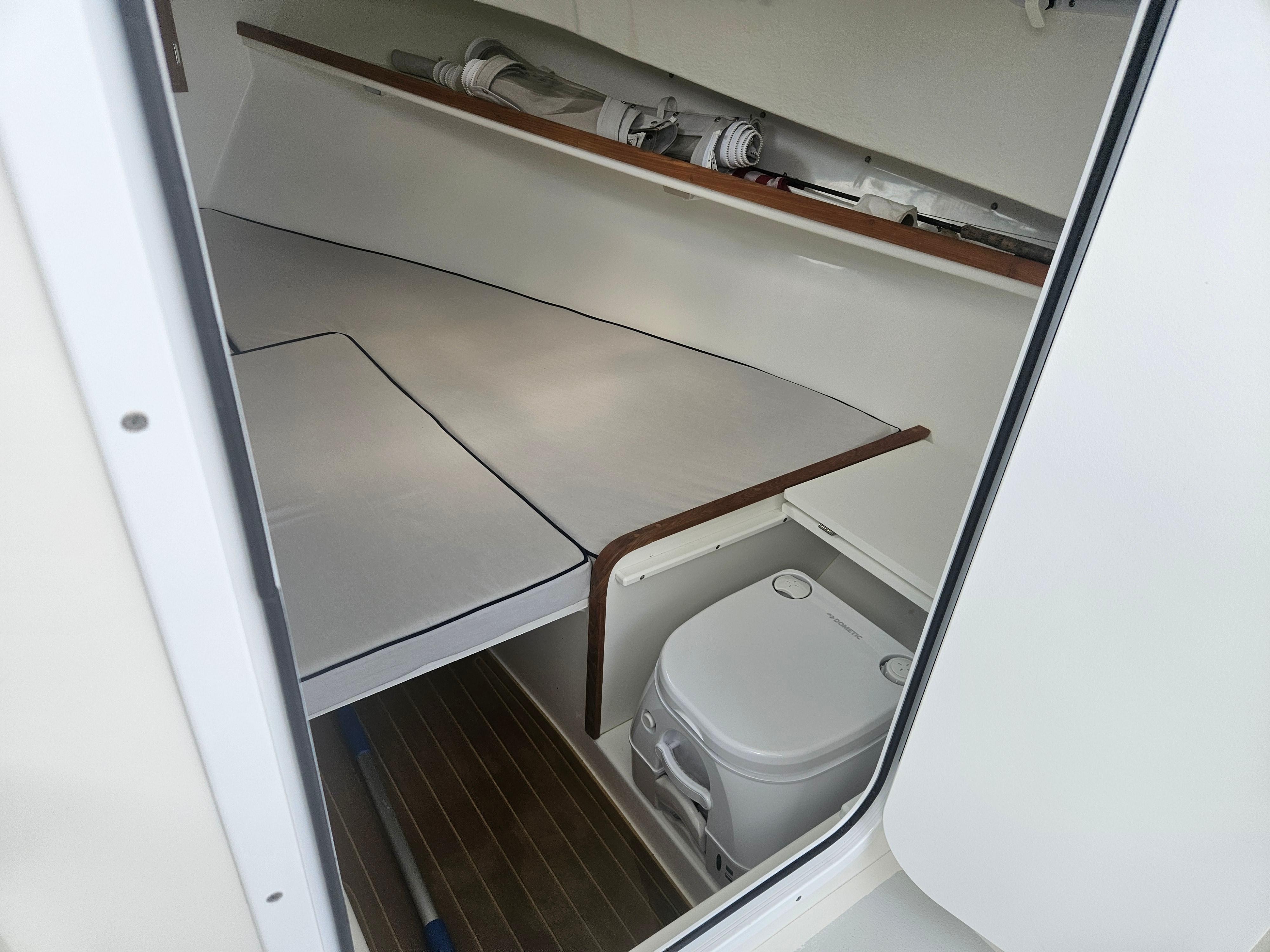 2019 Eastern 248 Explorer cabin interior with bed and portable toilet.