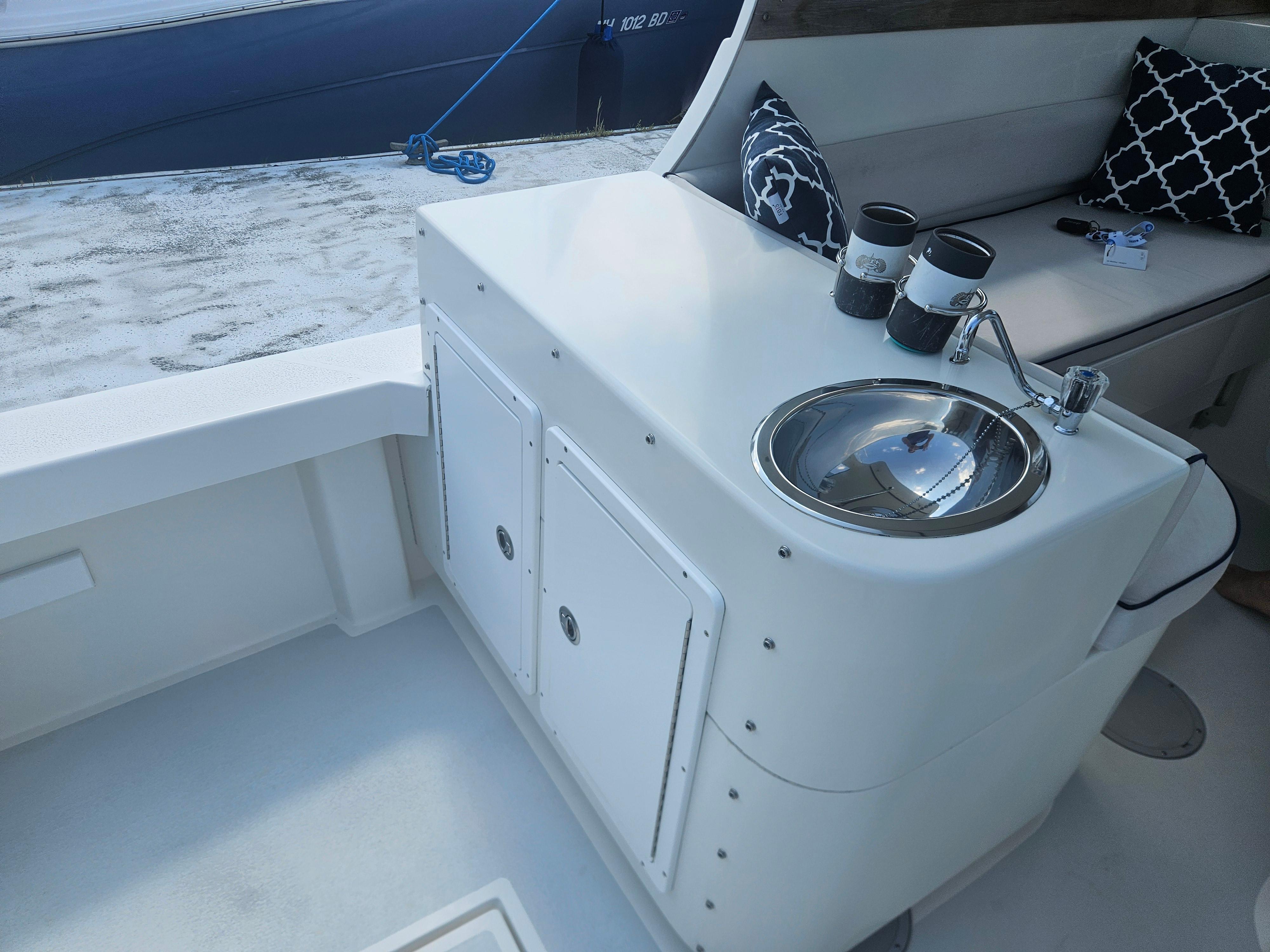 2019 Eastern 248 Explorer boat interior with sink, seating, and nautical decor.