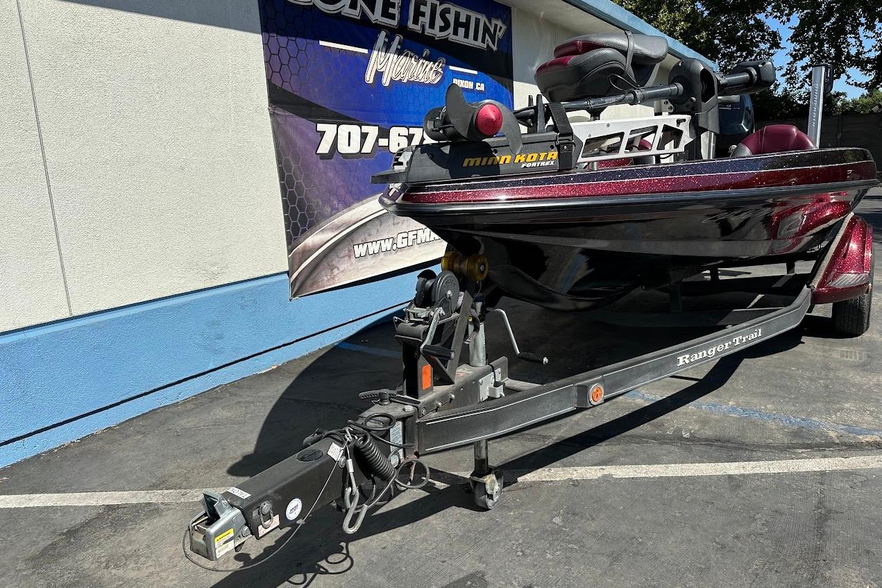 2010 Ranger 178 VS boat on trailer, parked outside a building with a promotional banner.