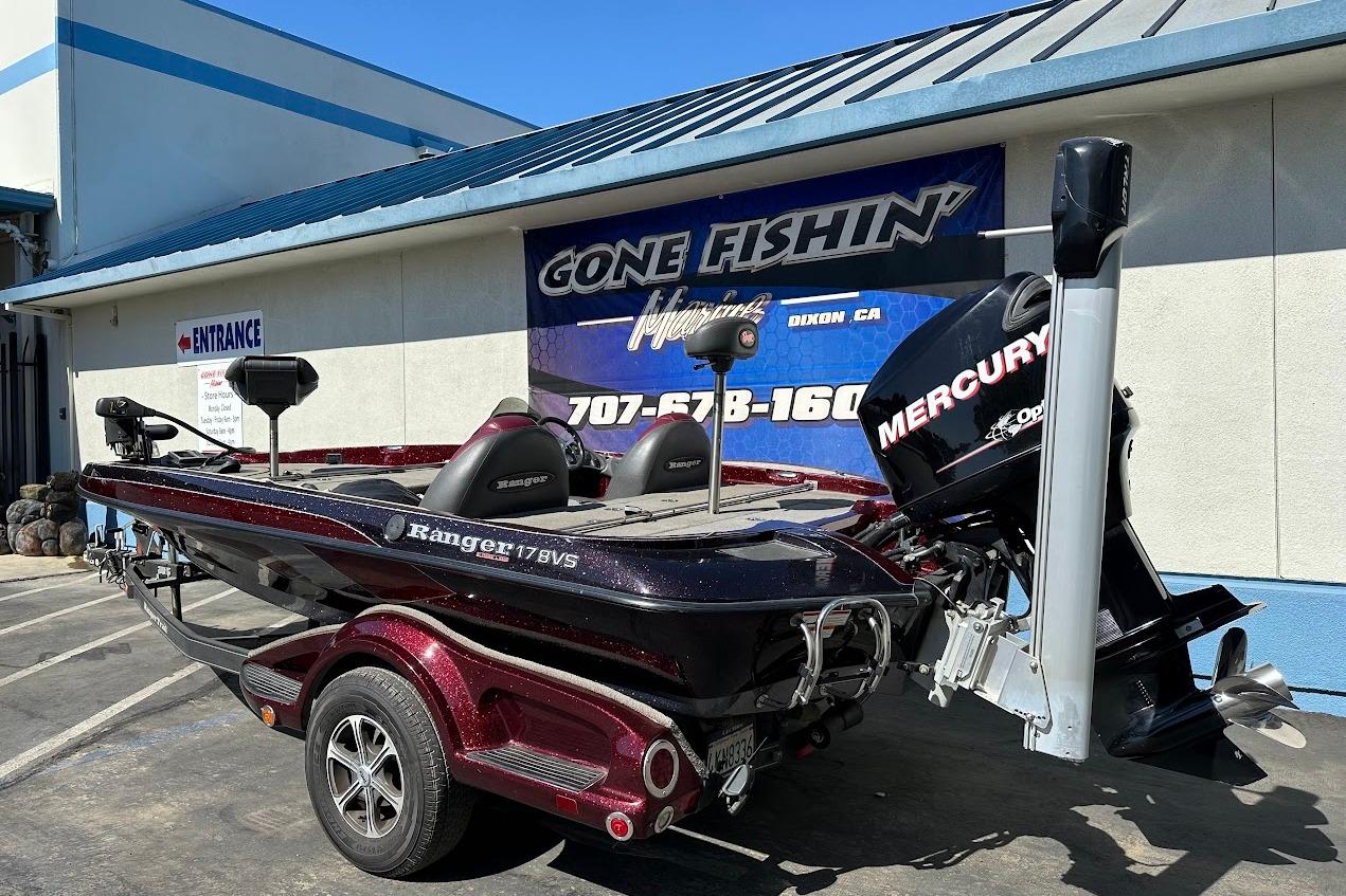 2010 Ranger 178 VS boat with Mercury engine parked outside a fishing store.