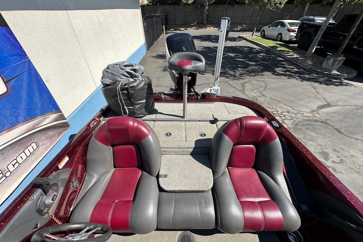 2010 Ranger 178 VS boat interior with red and gray seats, parked outdoors.