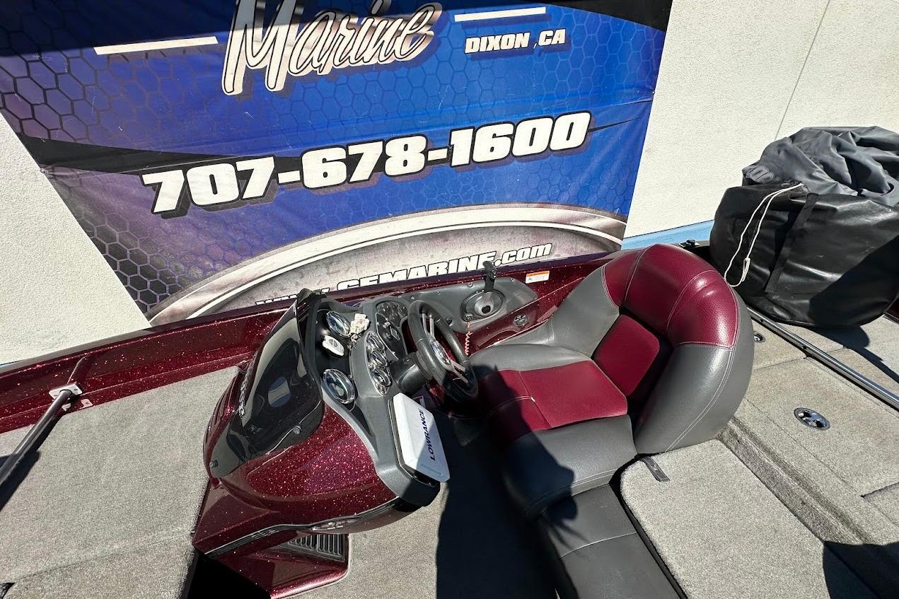 2010 Ranger 178 VS boat interior with maroon and gray seating, dashboard, and control panel.