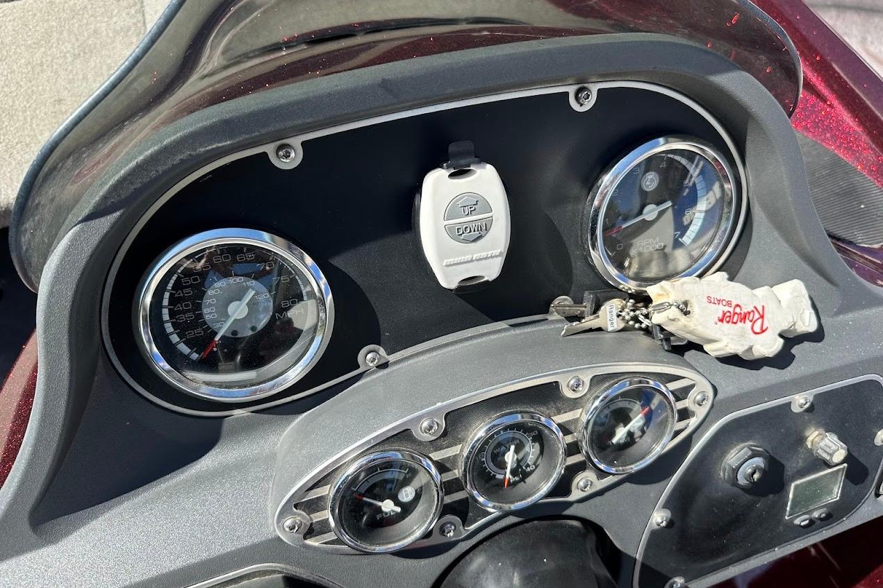 Dashboard of a 2010 Ranger 178 VS boat with gauges and keychain.