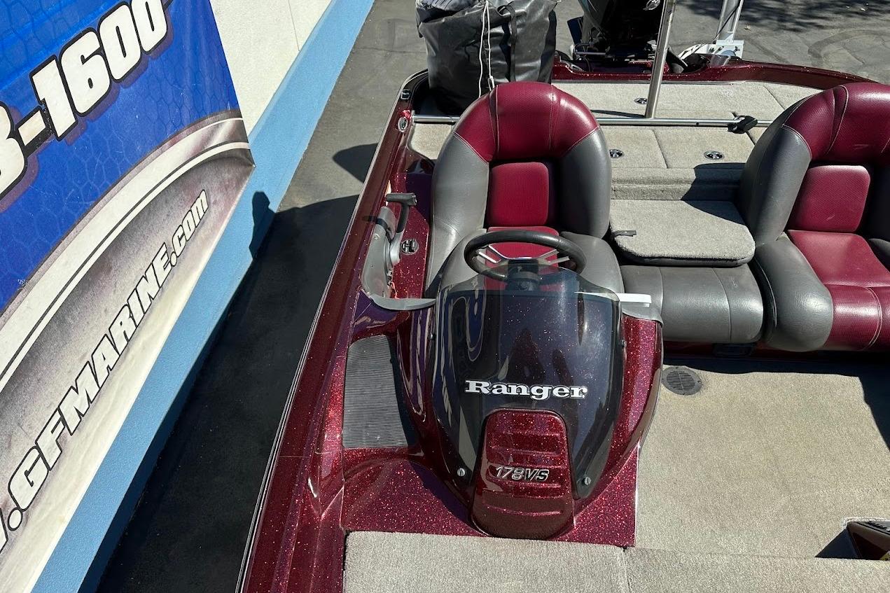 2010 Ranger 178 VS boat interior with red and gray seating, steering console, and branding.