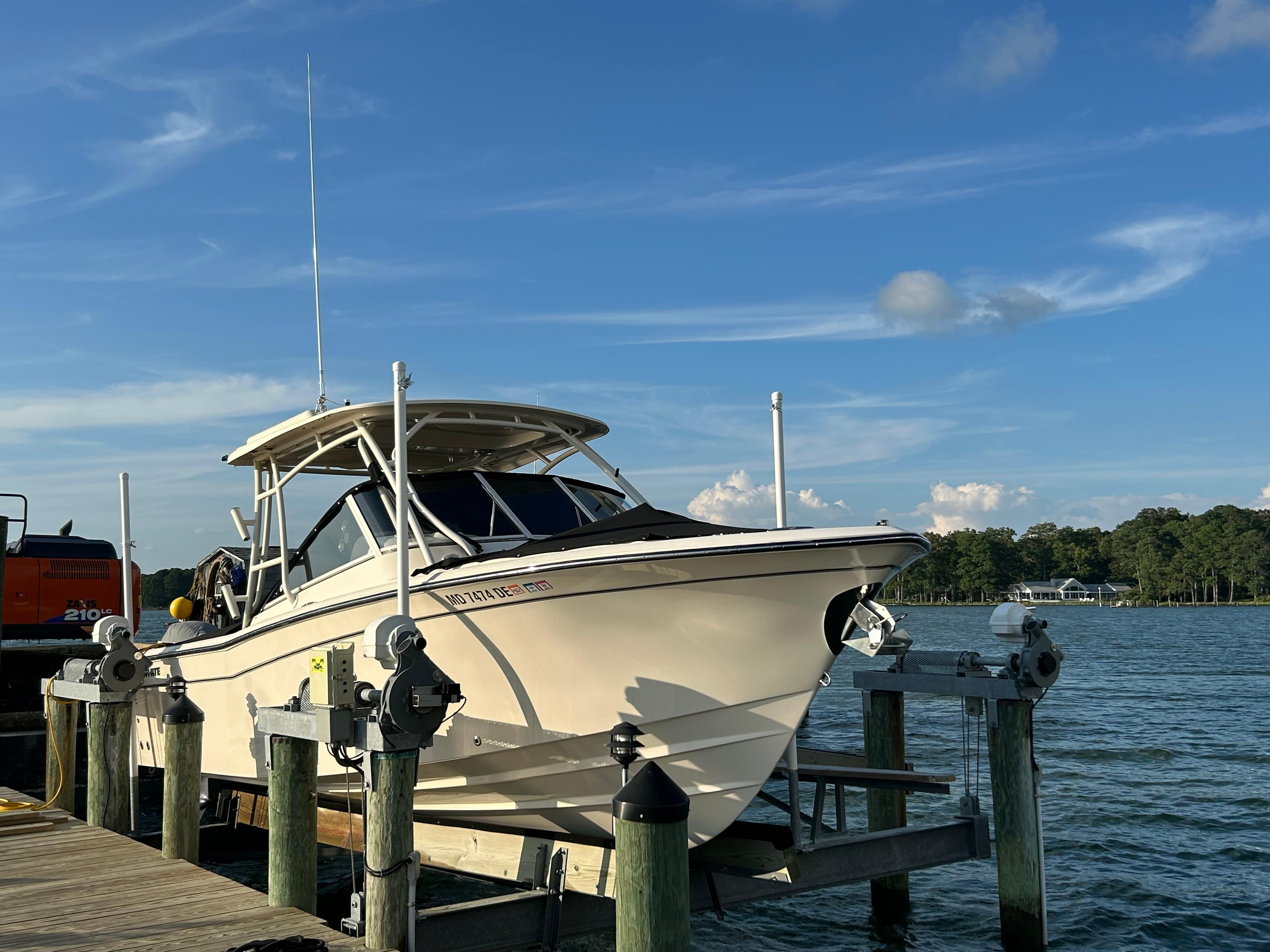 2023 Grady-White Freedom 275 boat docked on a sunny day by the water.