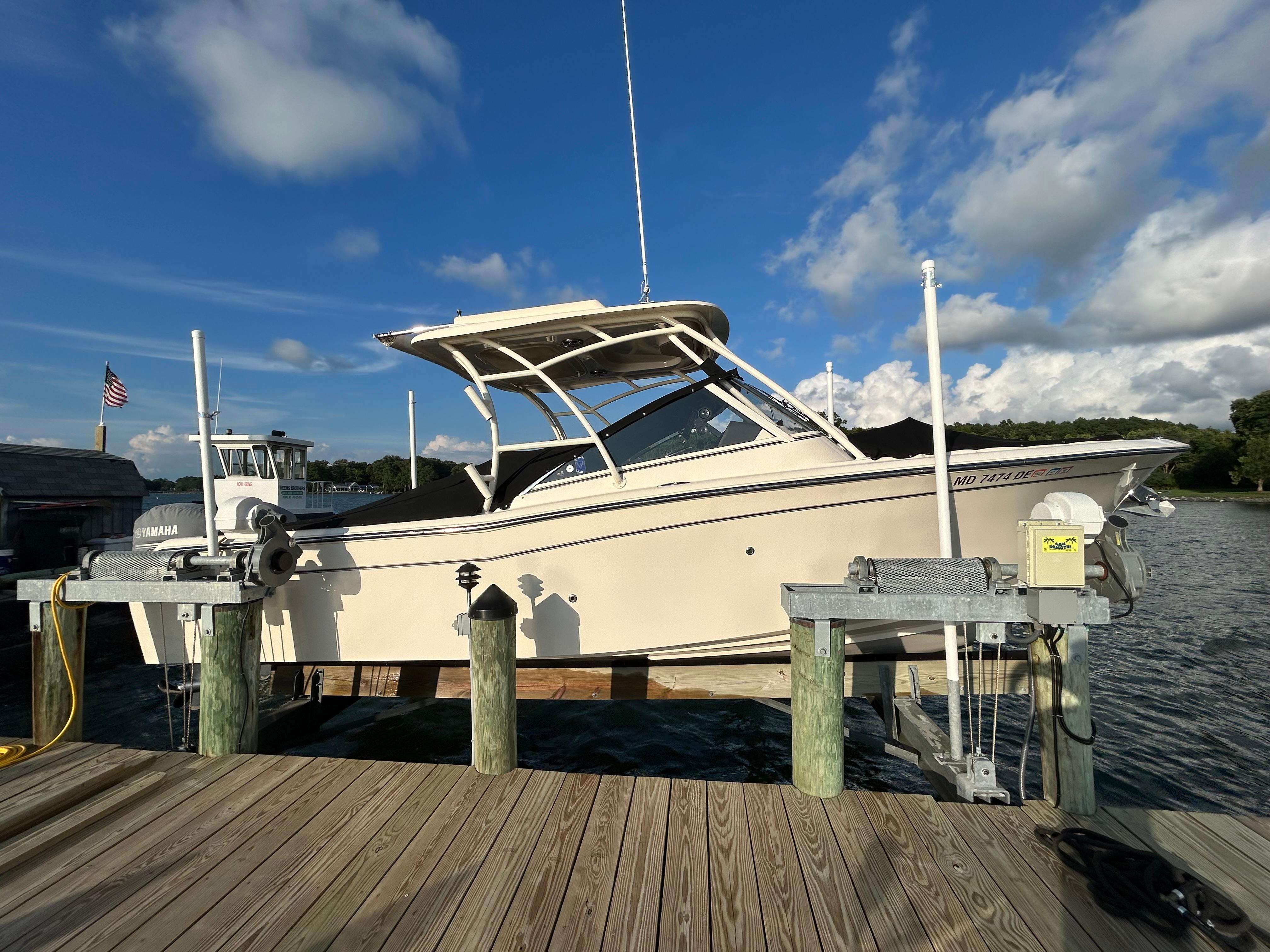 2023 Grady-White Freedom 275 boat docked under blue sky.