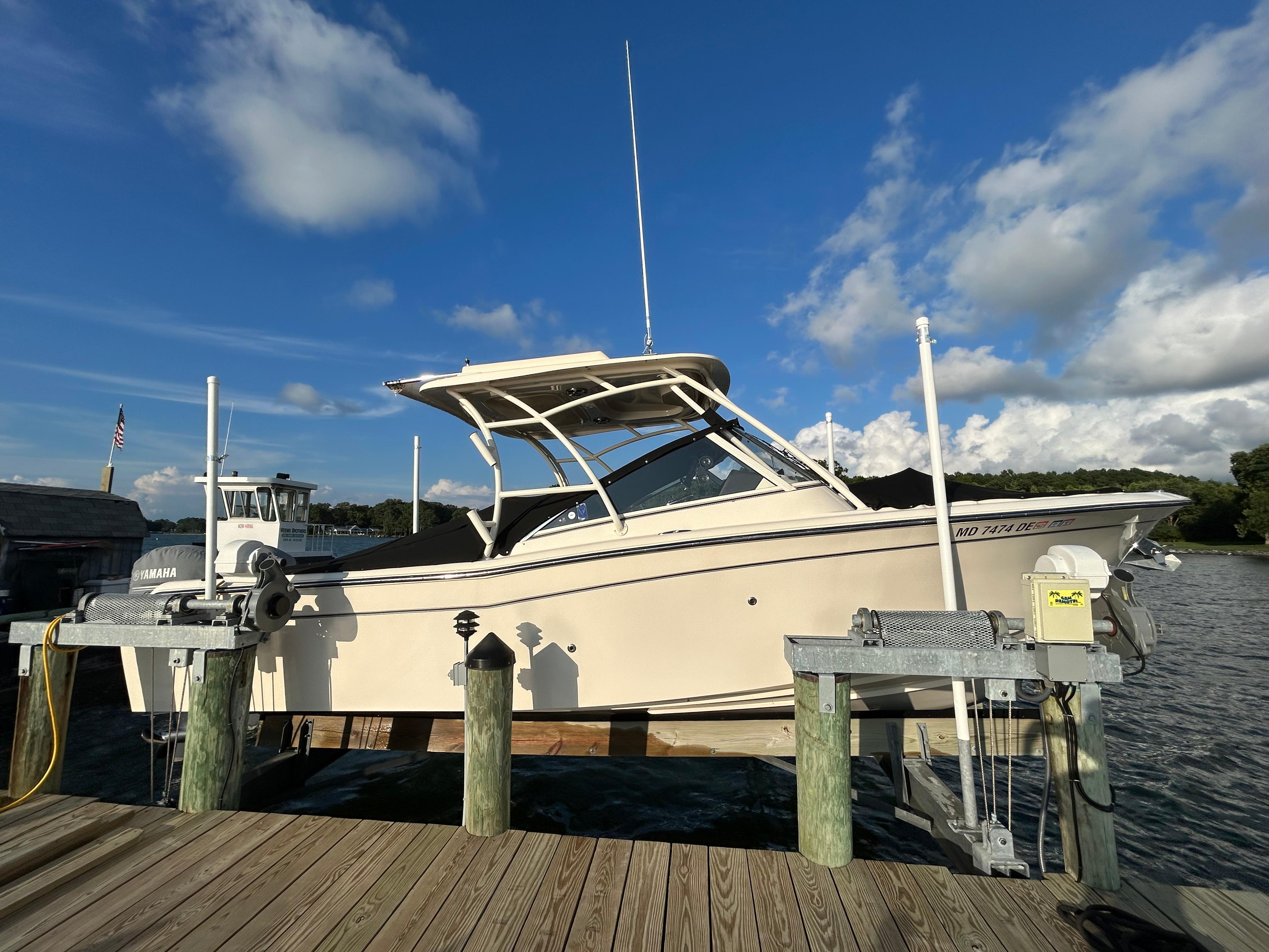 2023 Grady-White Freedom 275 boat docked under a clear blue sky.