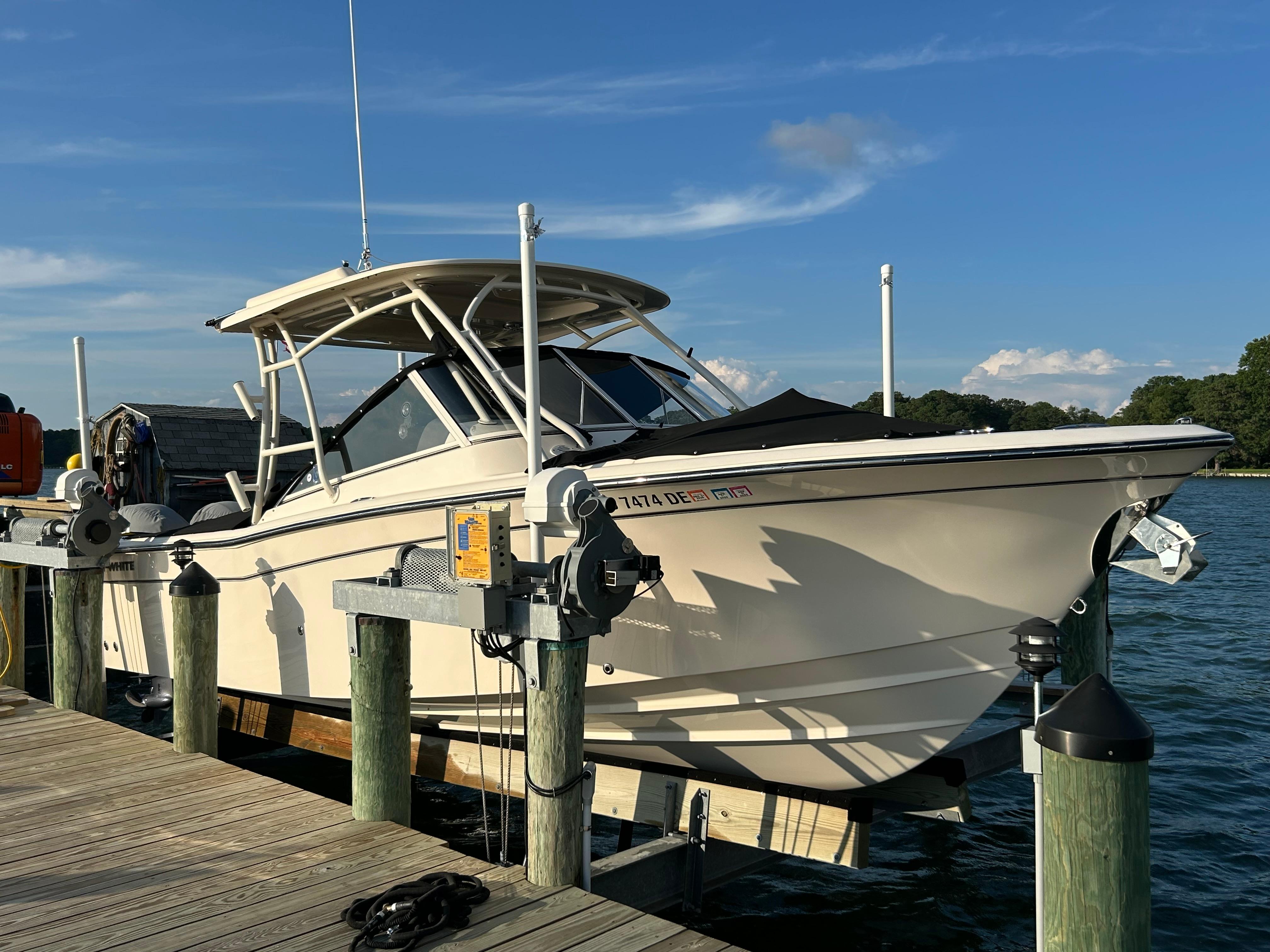 2023 Grady-White Freedom 275 boat docked on a sunny day.
