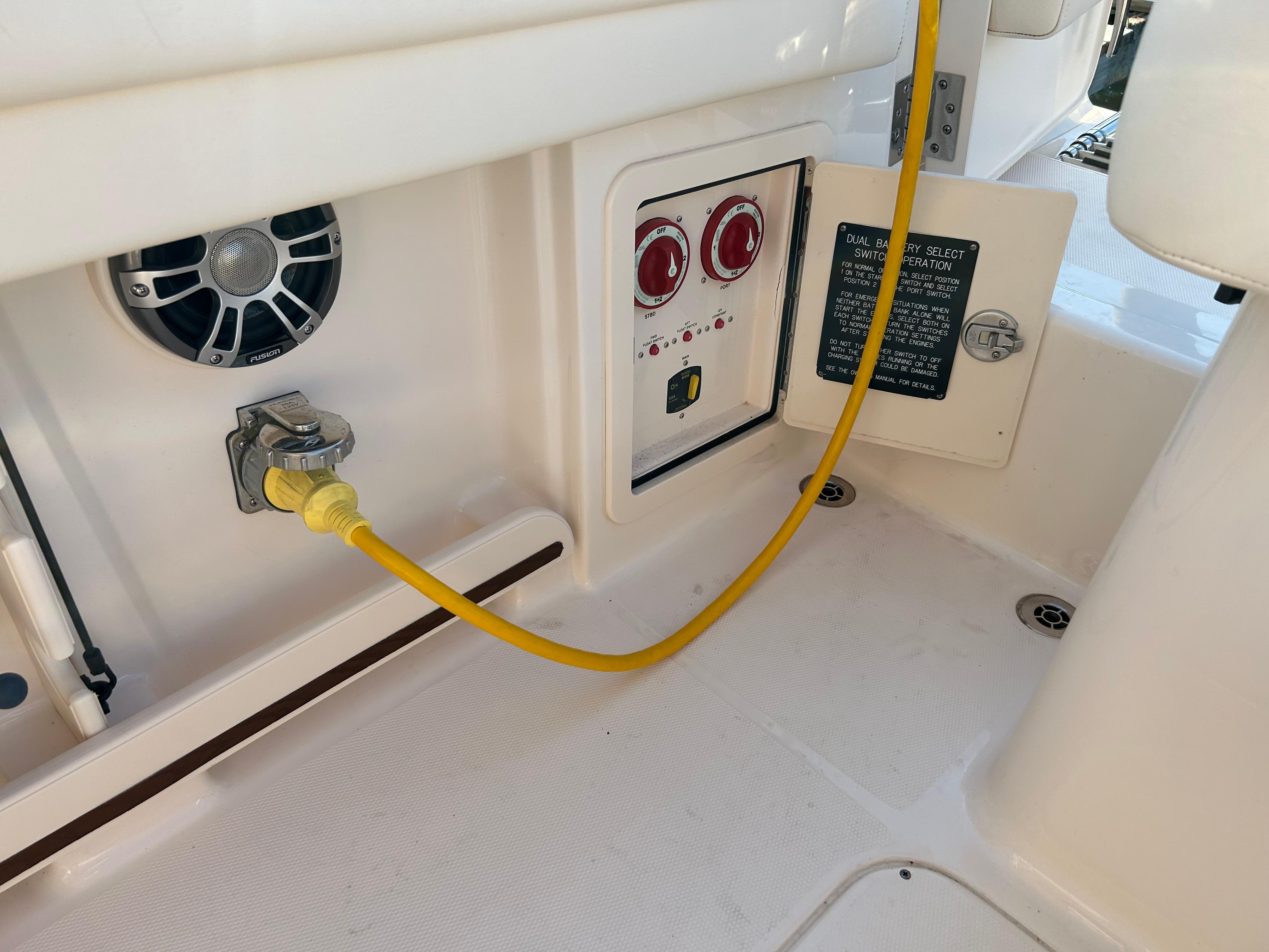 2023 Grady-White Freedom 275 boat interior with control panel and yellow power cable.