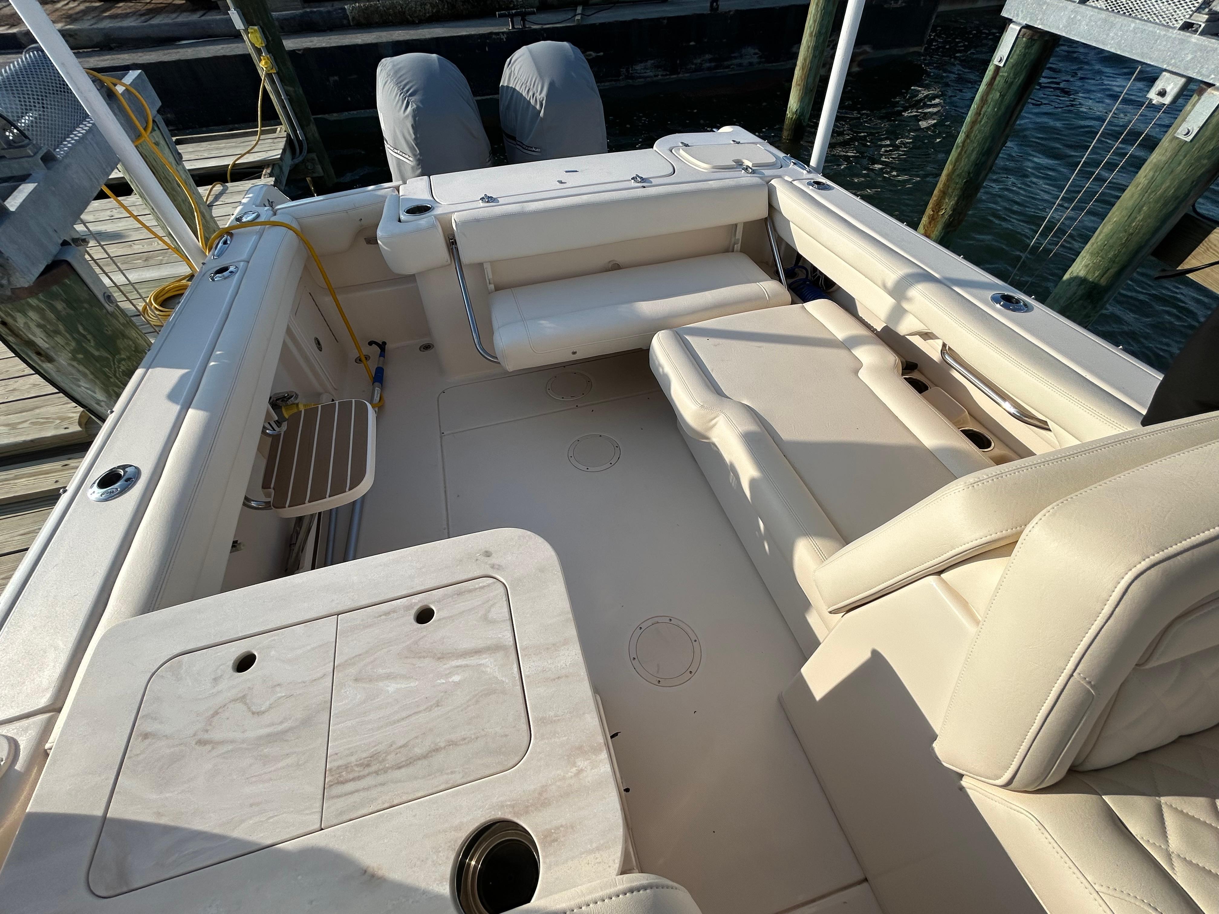2023 Grady-White Freedom 275 boat interior with seating and storage, docked by the water.