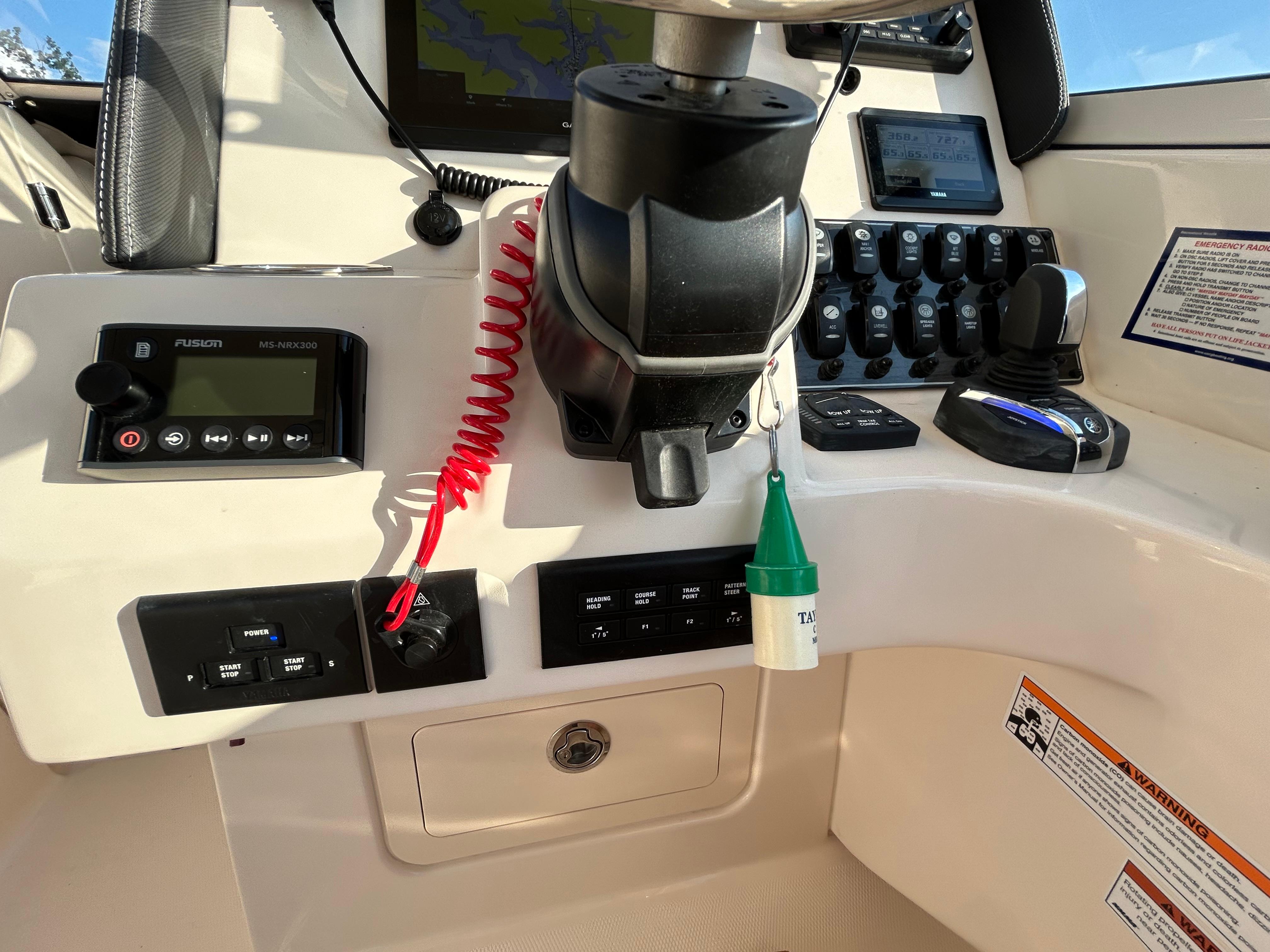 Control panel of 2023 Grady-White Freedom 275 boat with navigation and audio systems.