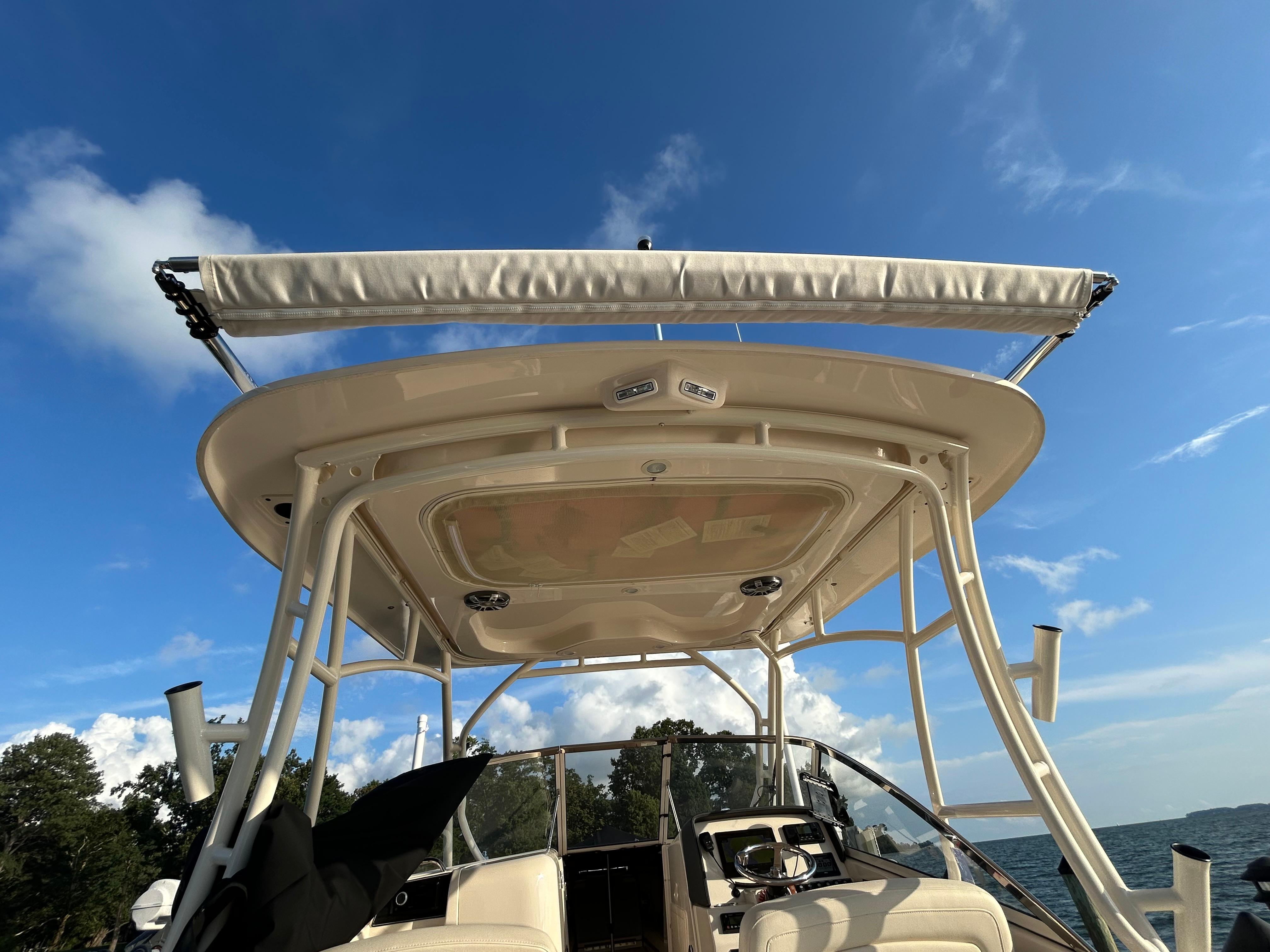 2023 Grady-White Freedom 275 boat, featuring a sleek canopy under a clear blue sky.