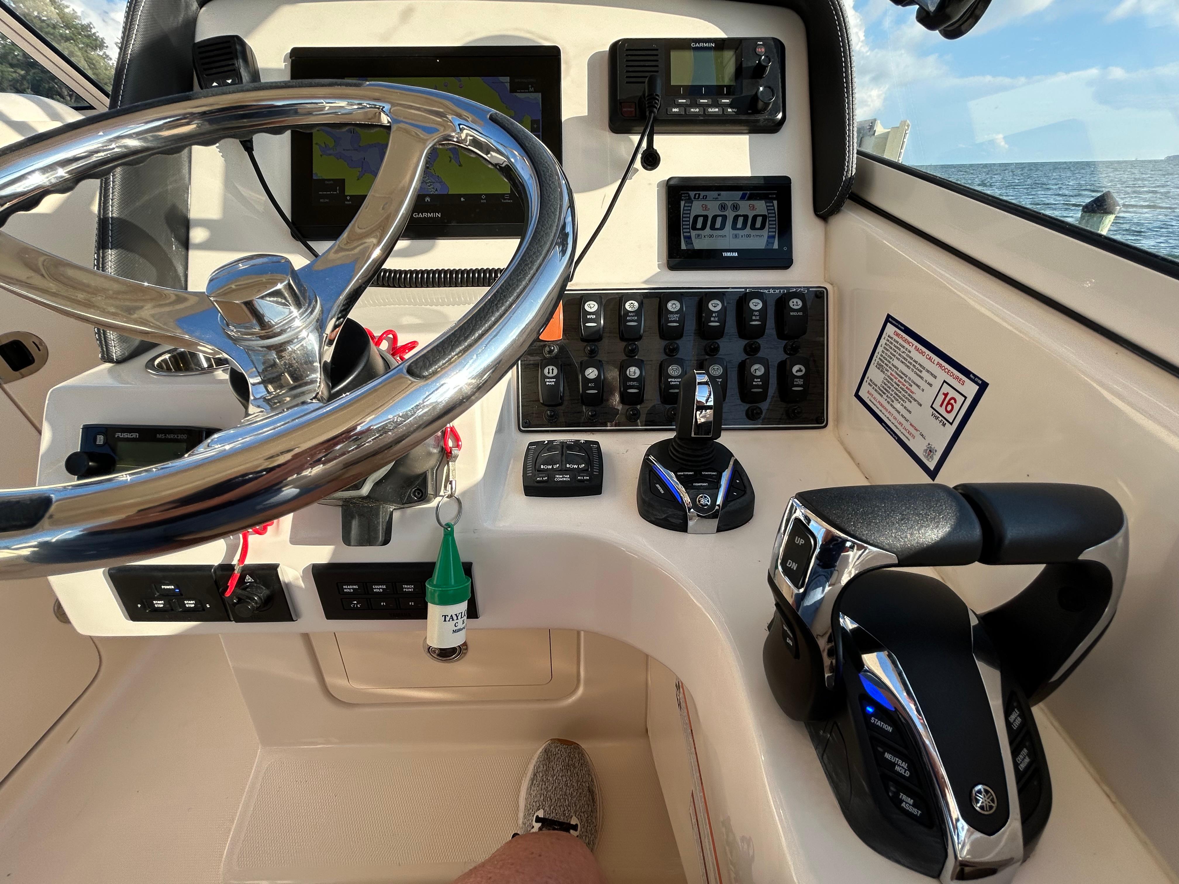 2023 Grady-White Freedom 275 boat dashboard with steering wheel and control panel.