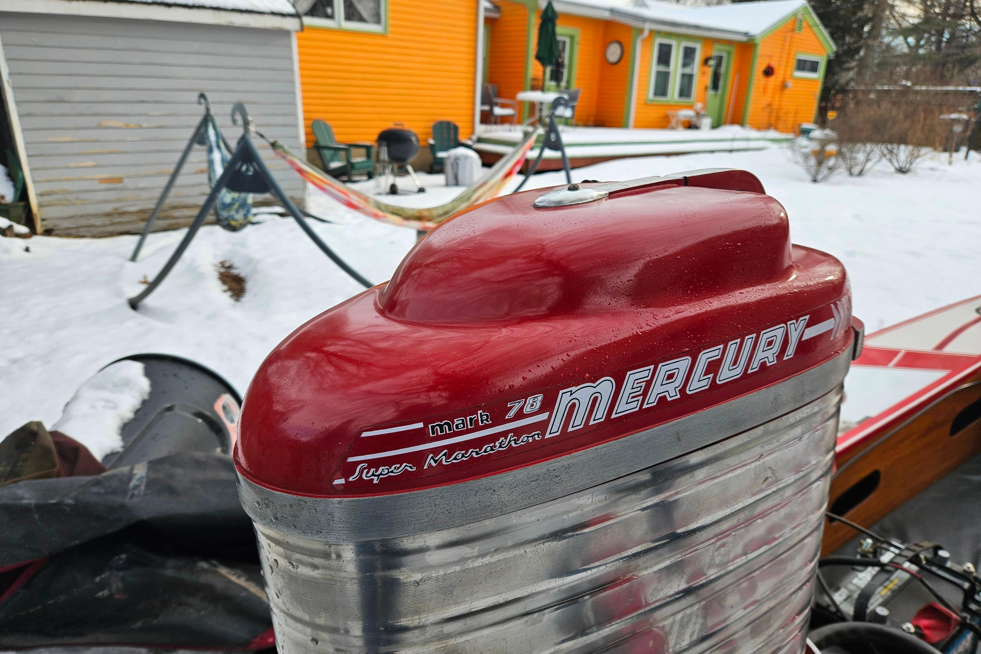 Red Mercury outboard motor on 1987 De Silva F Class Race boat, snowy backyard setting.