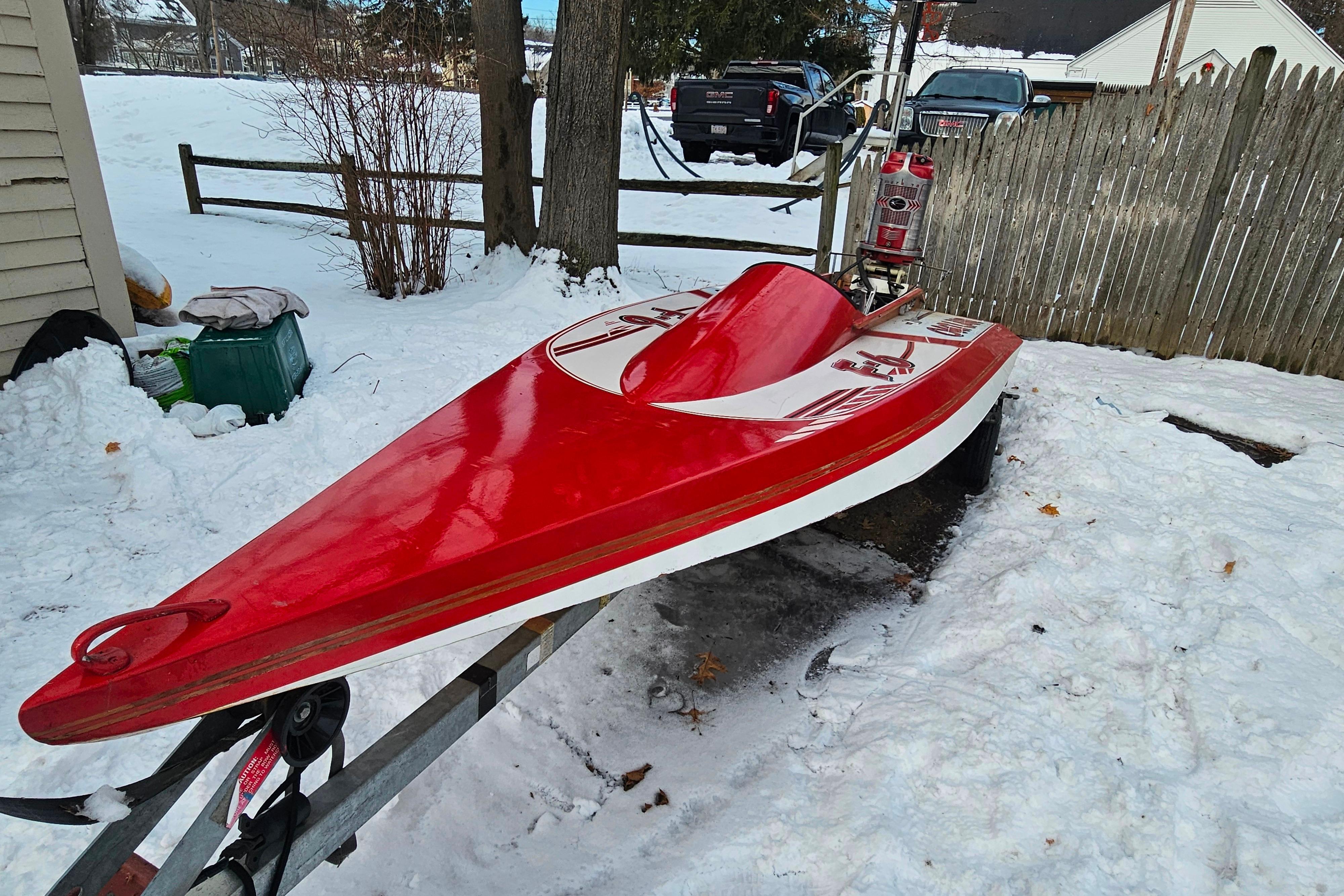 1987 De Silva F Class Race boat on trailer in snowy yard.