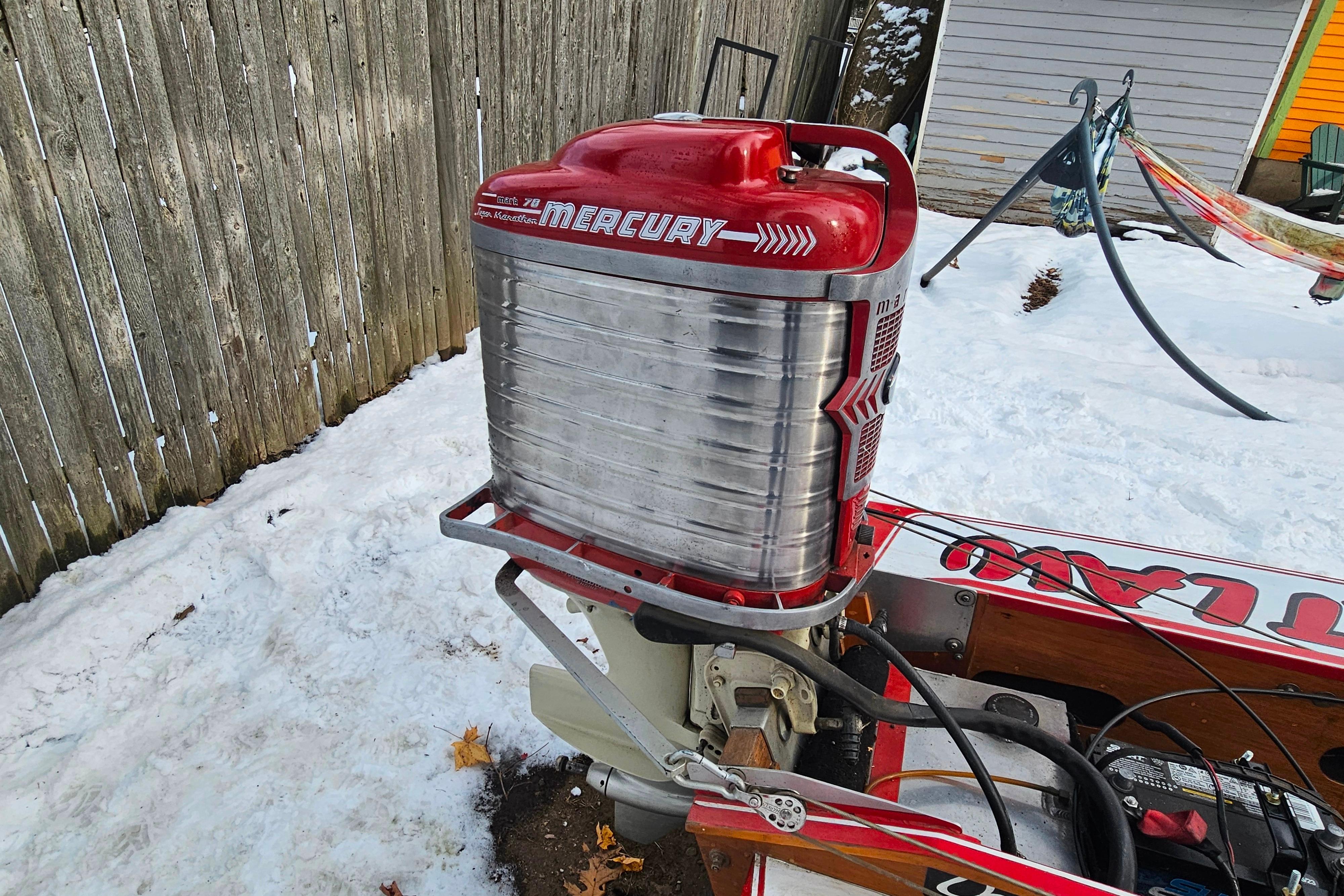 1987 De Silva F Class Race boat with Mercury engine in snowy yard.