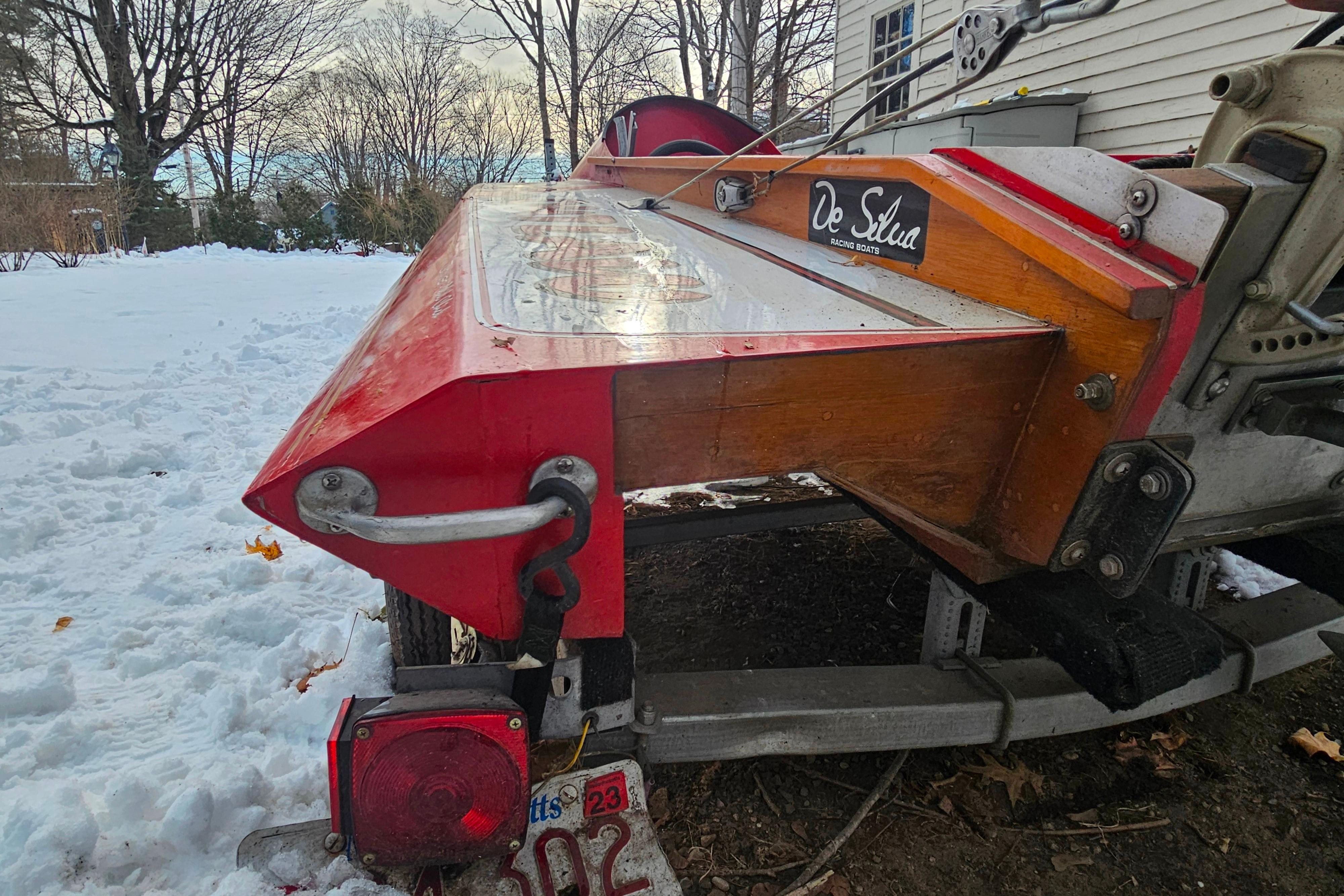1987 De Silva F Class Race boat on trailer in snowy yard.