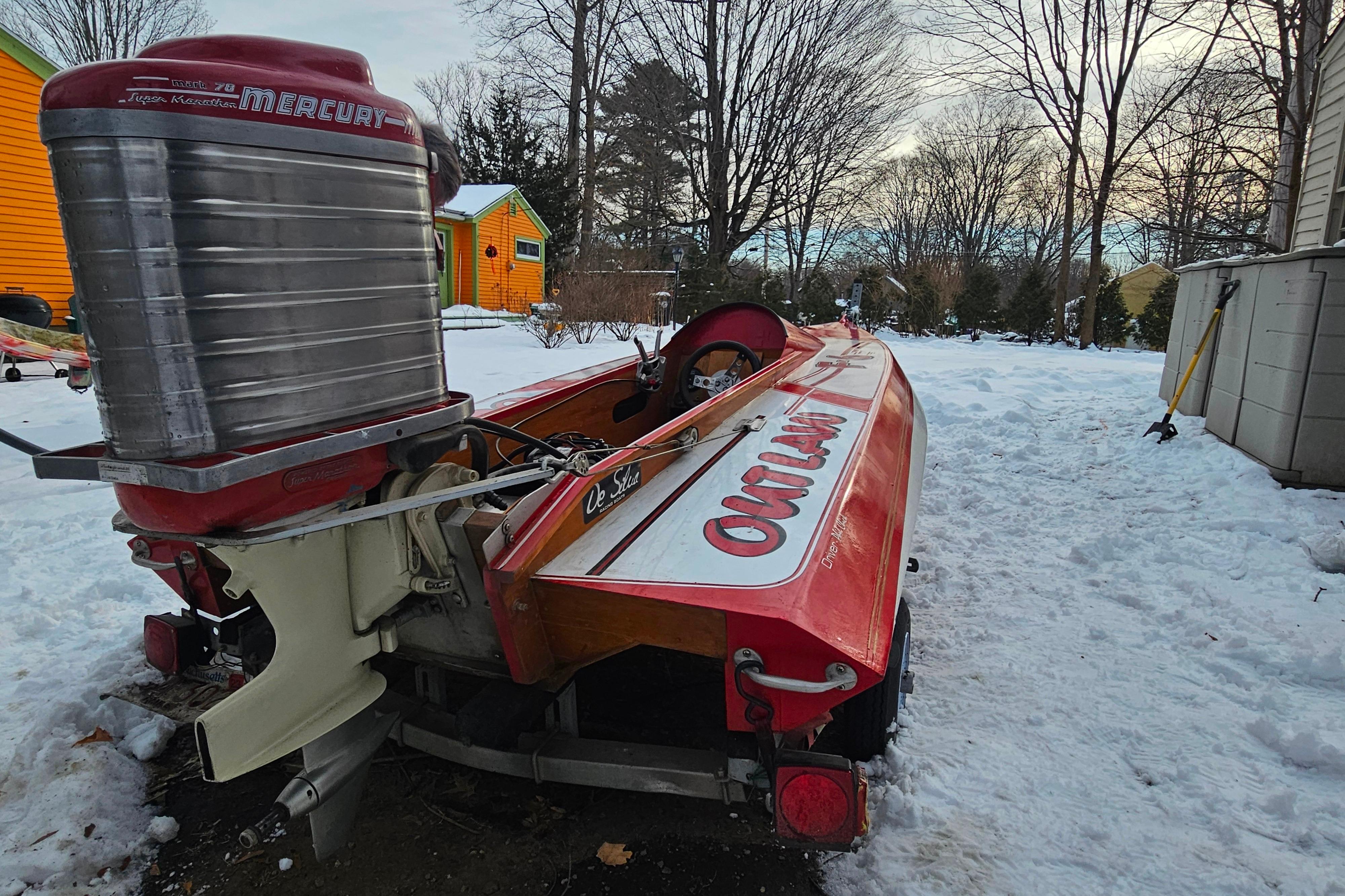 1987 De Silva F Class Race boat with Mercury engine in snowy yard.