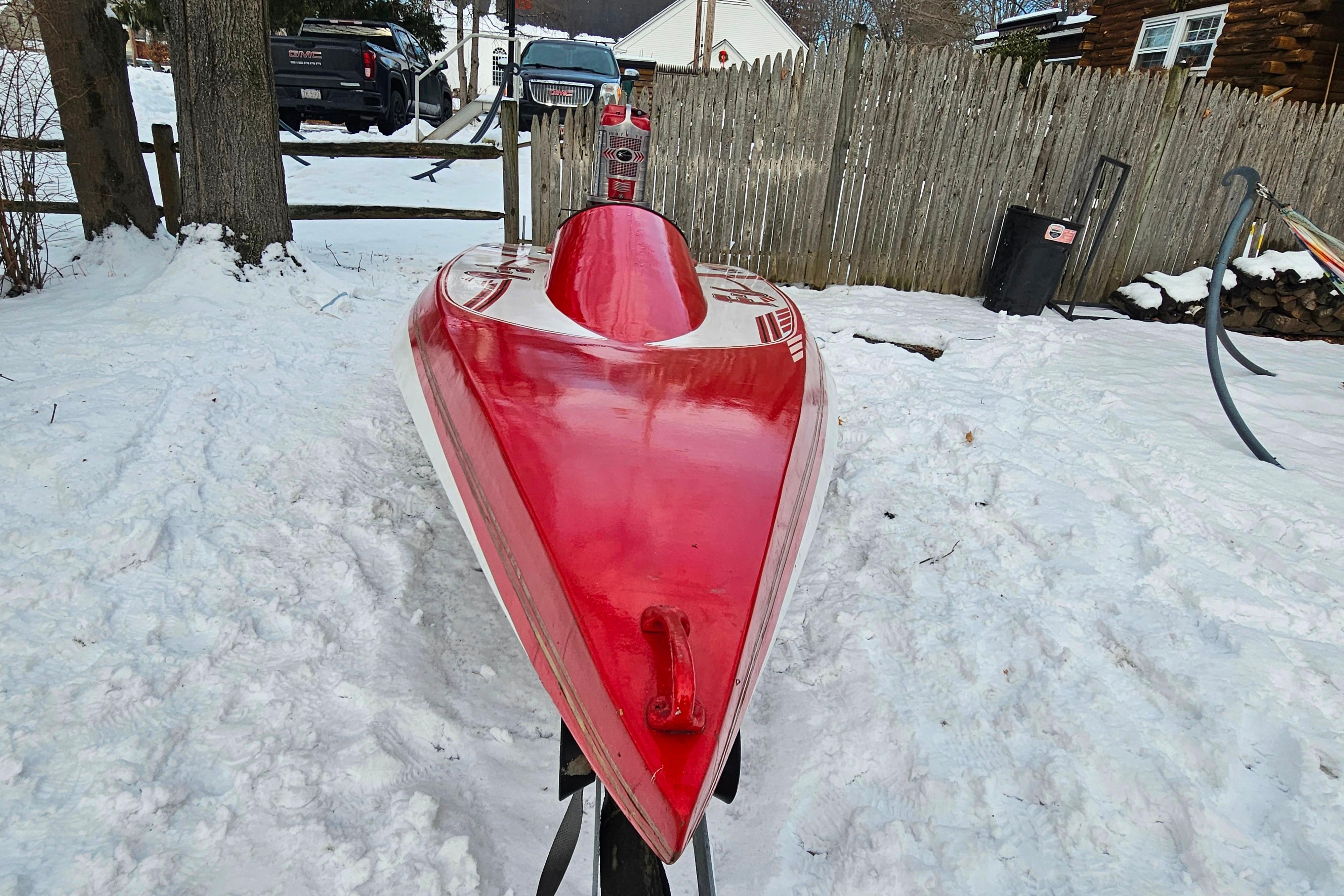 1987 De Silva F Class Race boat in snowy yard, red and white design.