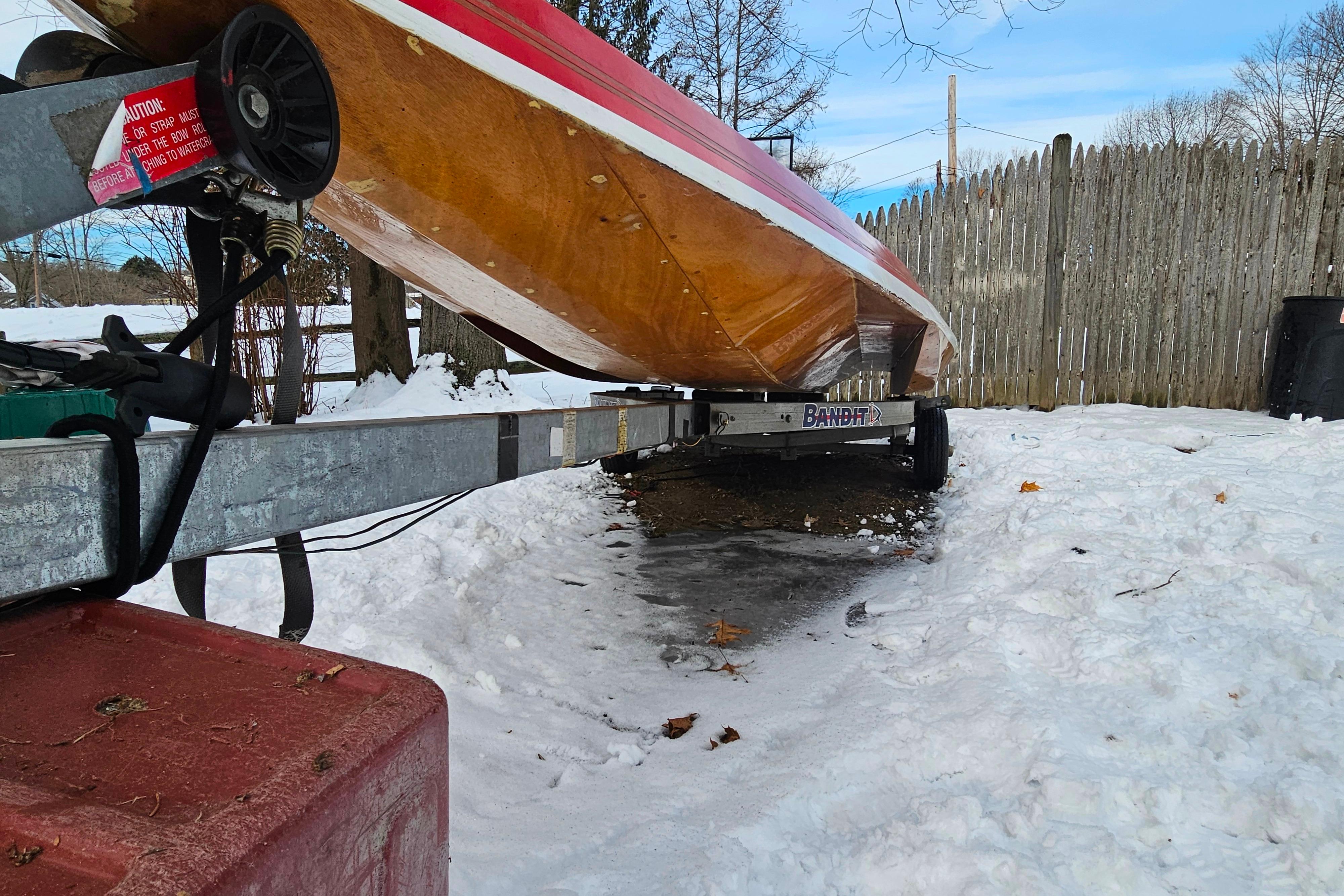 1987 De Silva F Class Race boat on trailer in snowy yard.