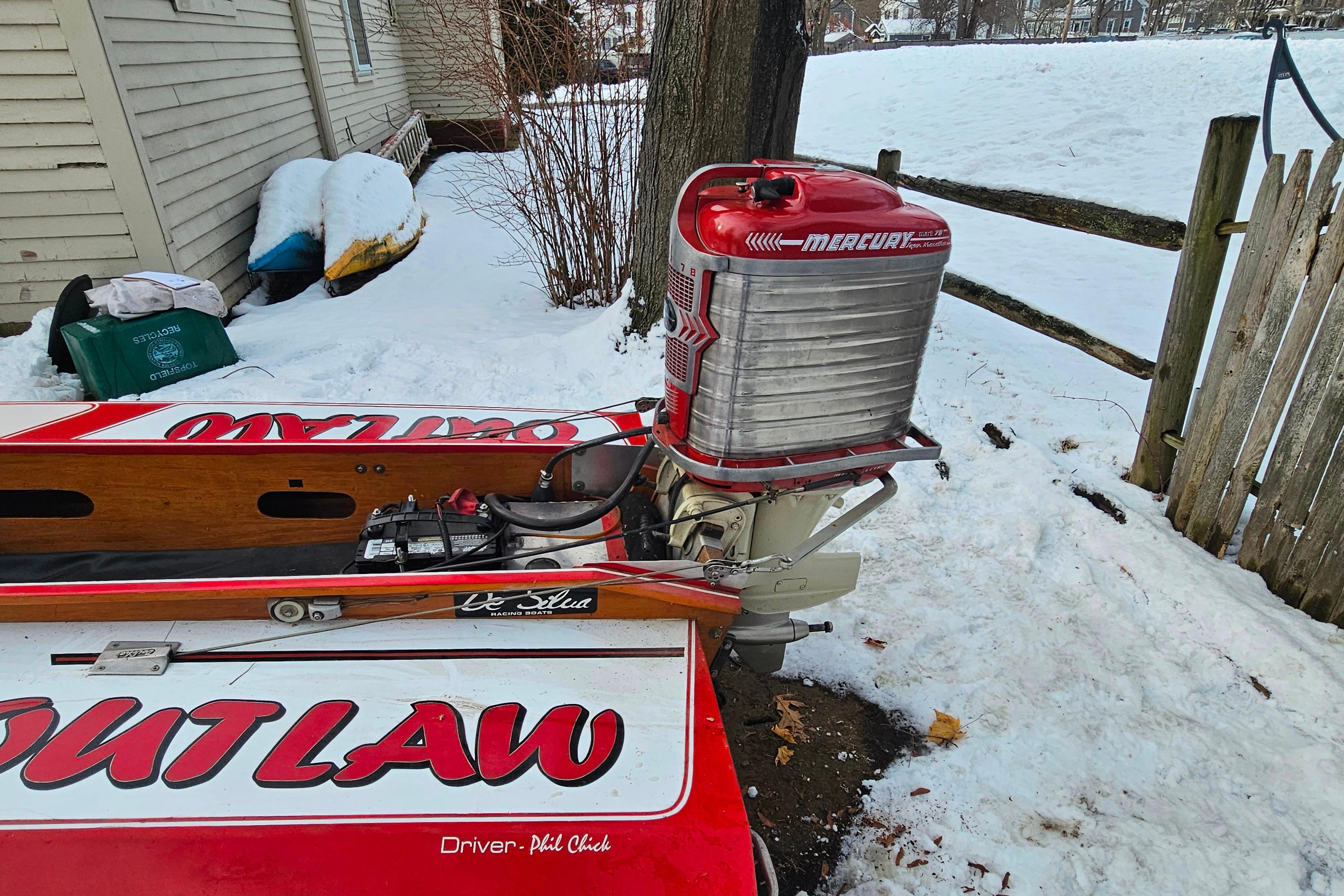 1987 De Silva F Class Race boat with Mercury engine in snowy yard.