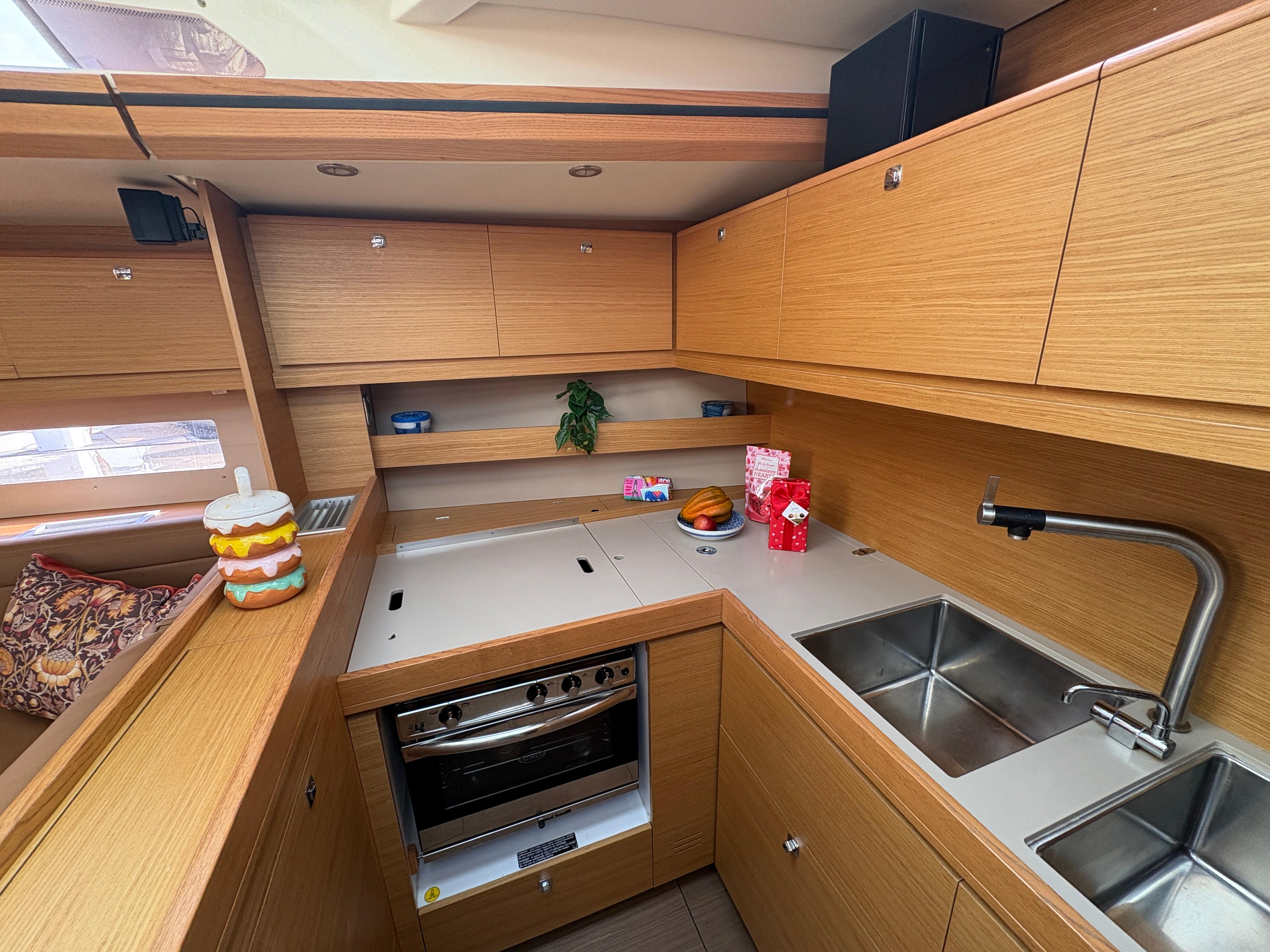 Dufour-560 Exclusive 2018-560 Exclusive US-Modern kitchen interior of 2018 Dufour 560 Exclusive yacht with wooden cabinetry and stainless steel sink.-9765971 | Thumbnail