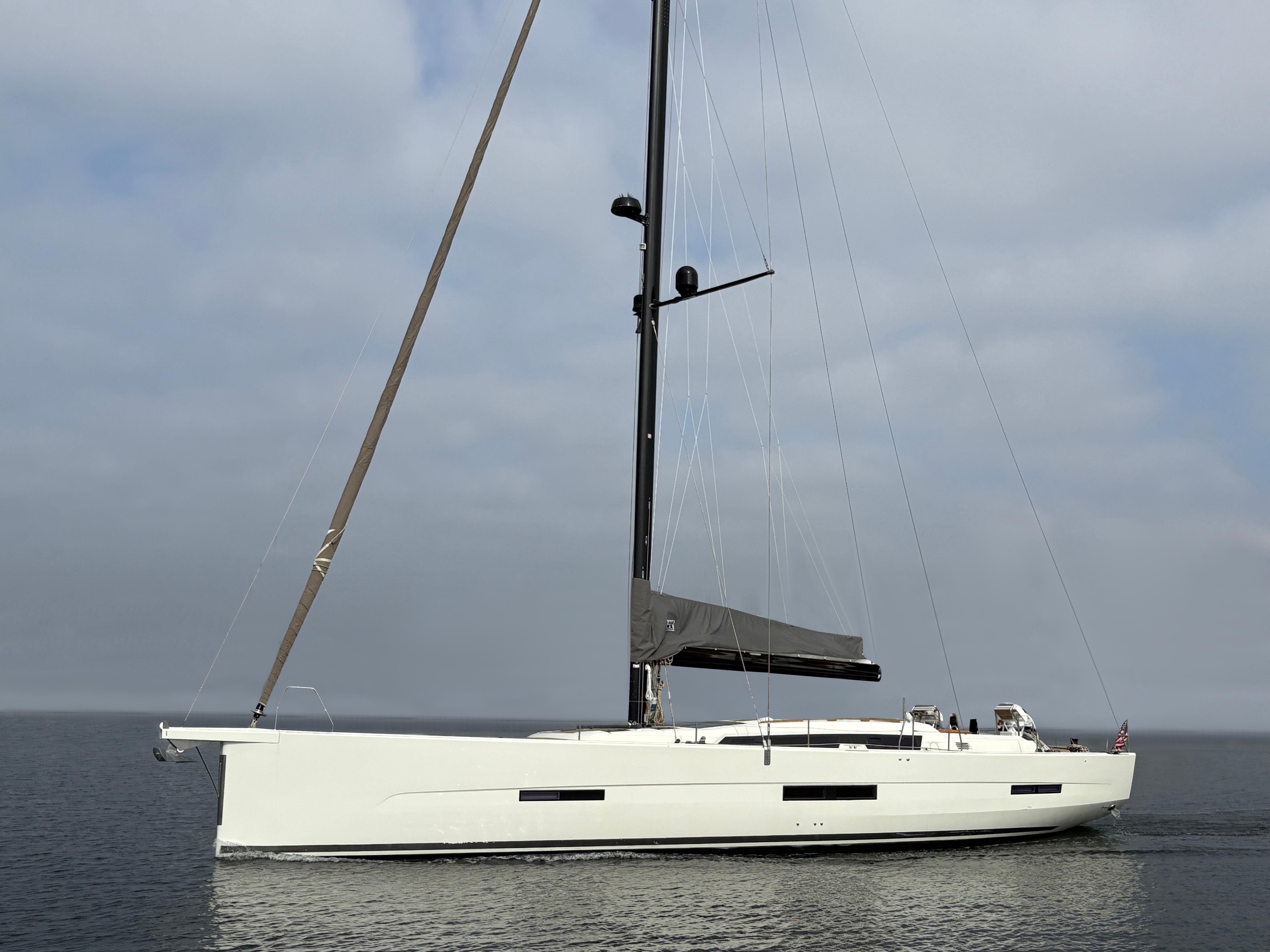Dufour-560 Exclusive 2018-560 Exclusive US-2018 Dufour 560 Exclusive sailboat on calm water under cloudy sky.-9765971