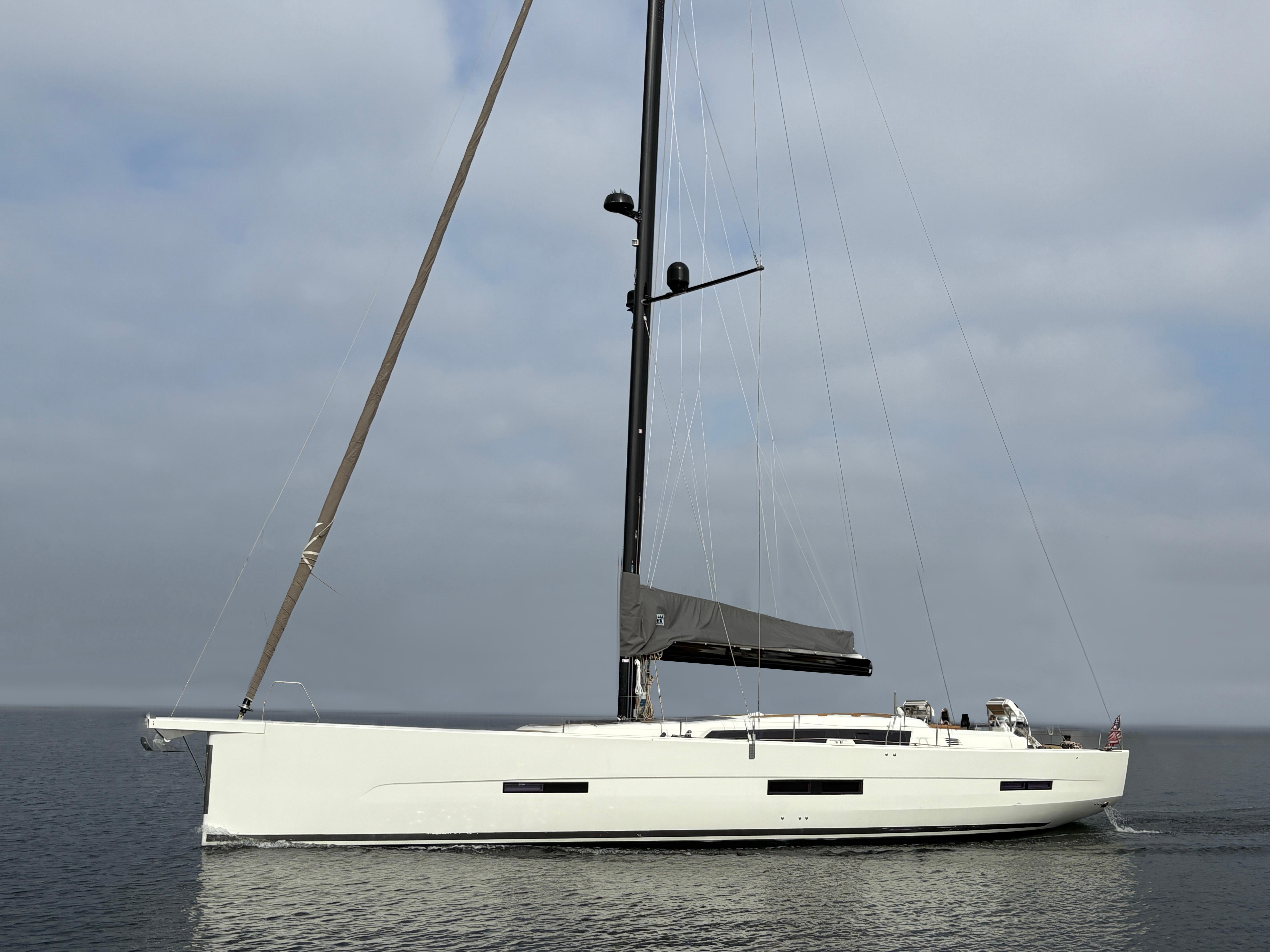 Dufour-560 Exclusive 2018-560 Exclusive US-2018 Dufour 560 Exclusive yacht sailing on calm waters under a cloudy sky.-9765971 | Thumbnail