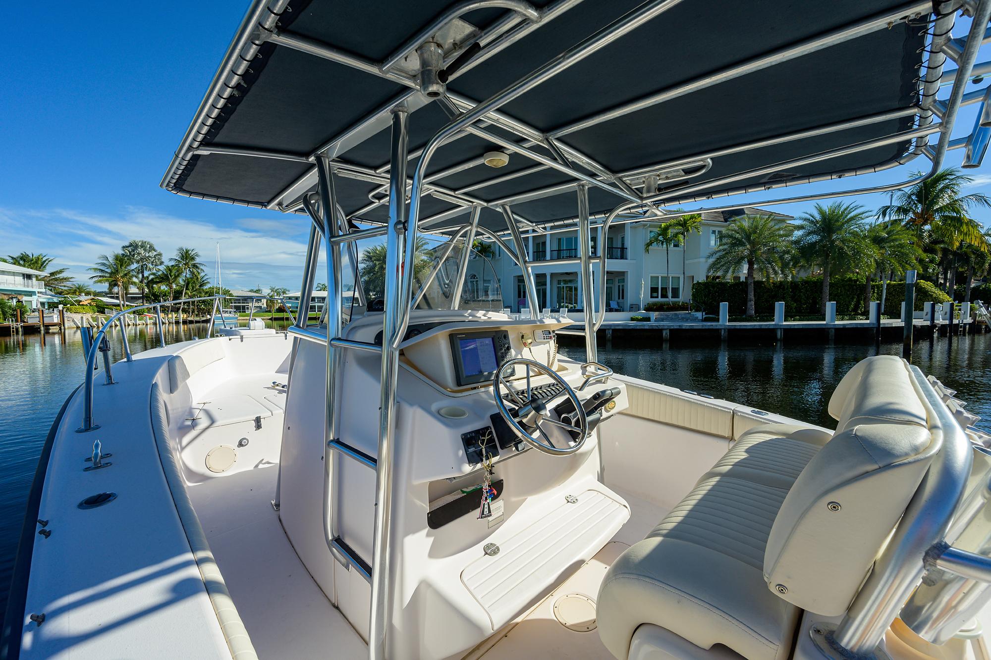 Grady-White 306 Bimini - Exterior portside helm seating and gauges profile on water