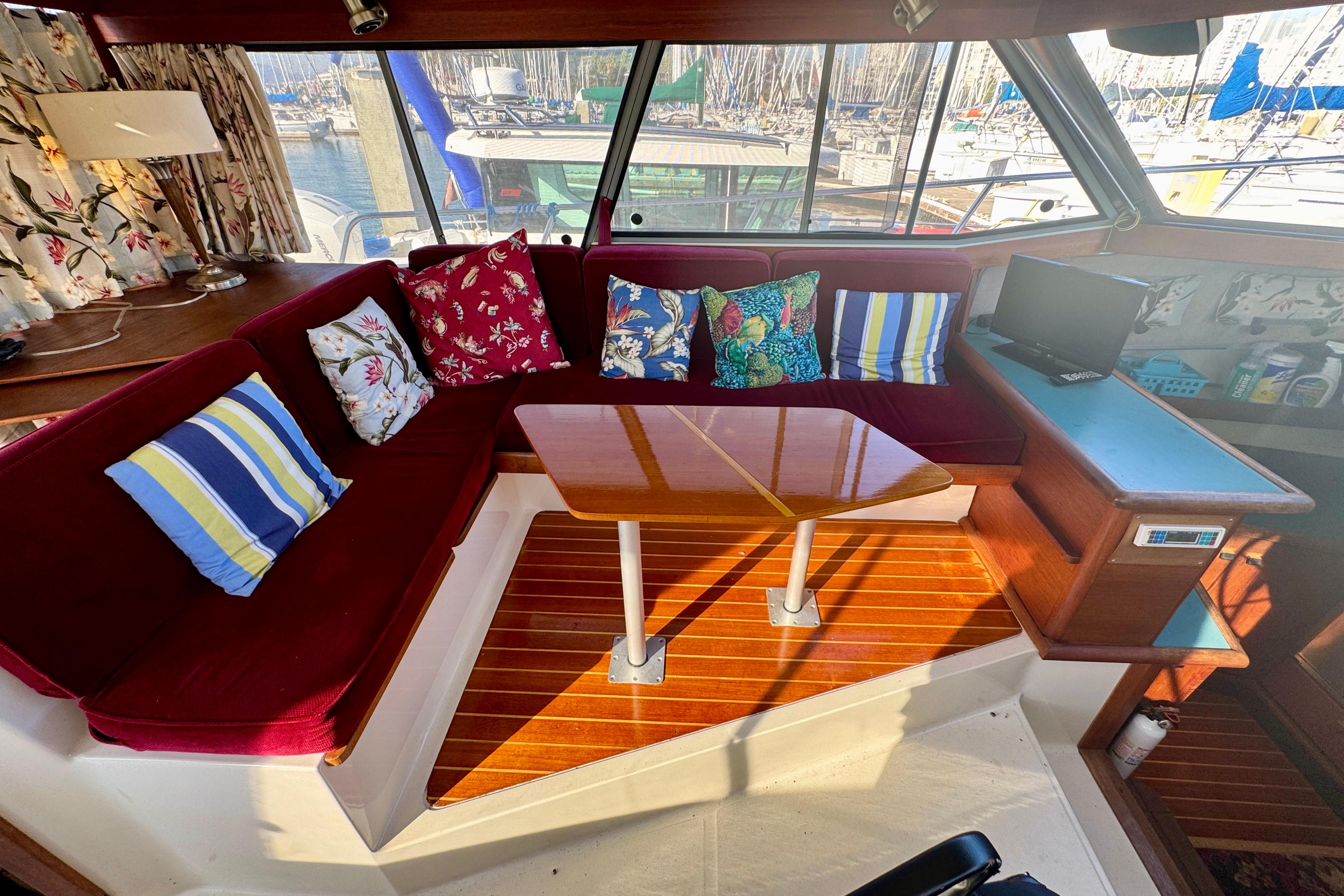 Interior of 1989 Bayliner 3288 Motoryacht with cozy seating and colorful cushions.