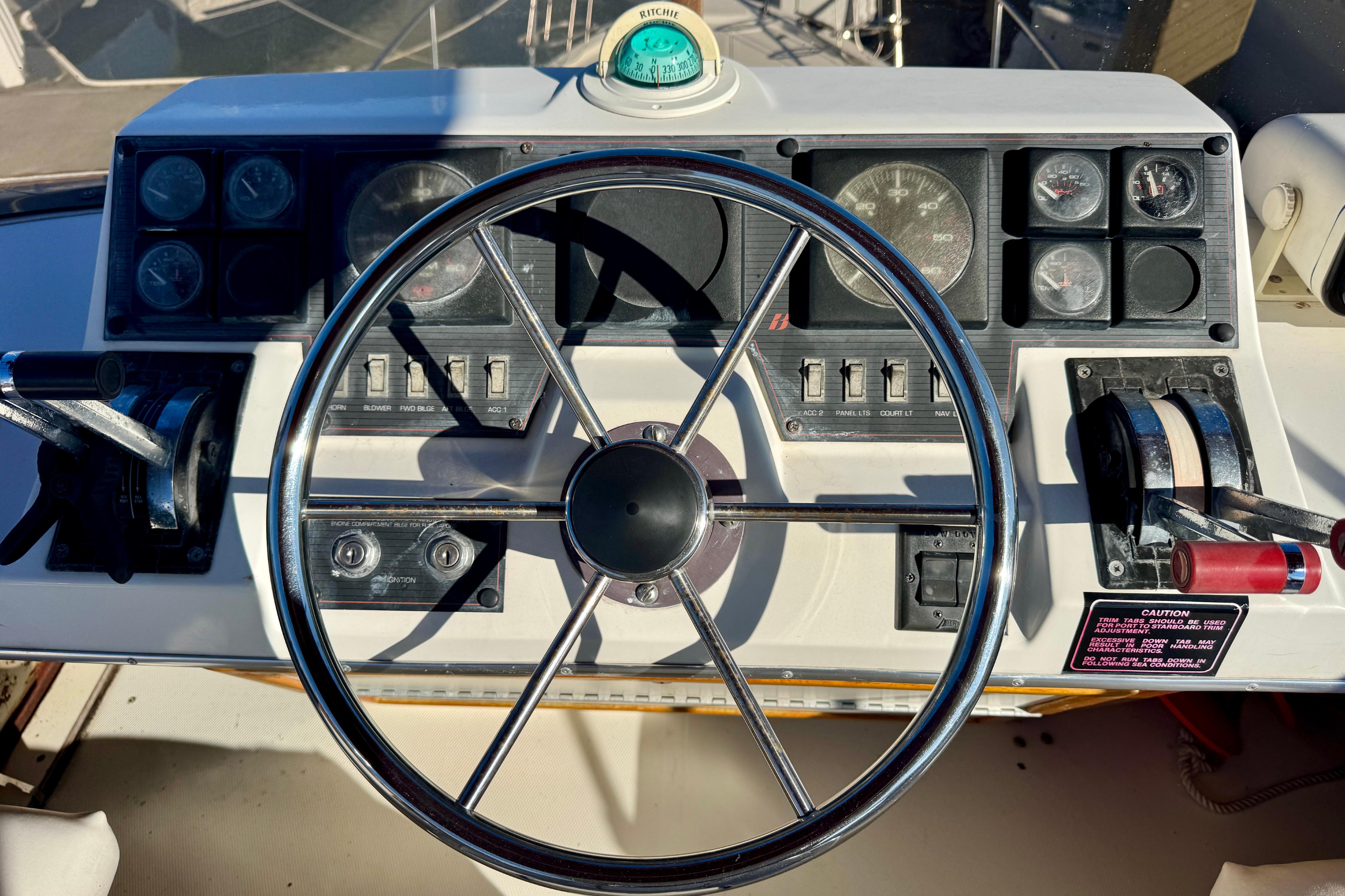 1989 Bayliner 3288 Motoryacht helm with steering wheel and control panel.