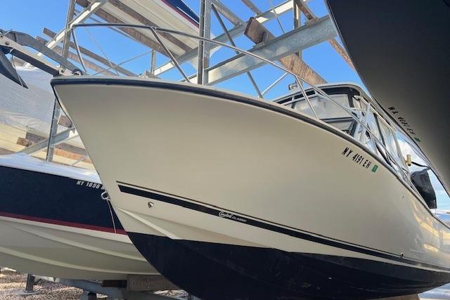 2001 Carolina Classic 25 Classic boat in storage, side view.