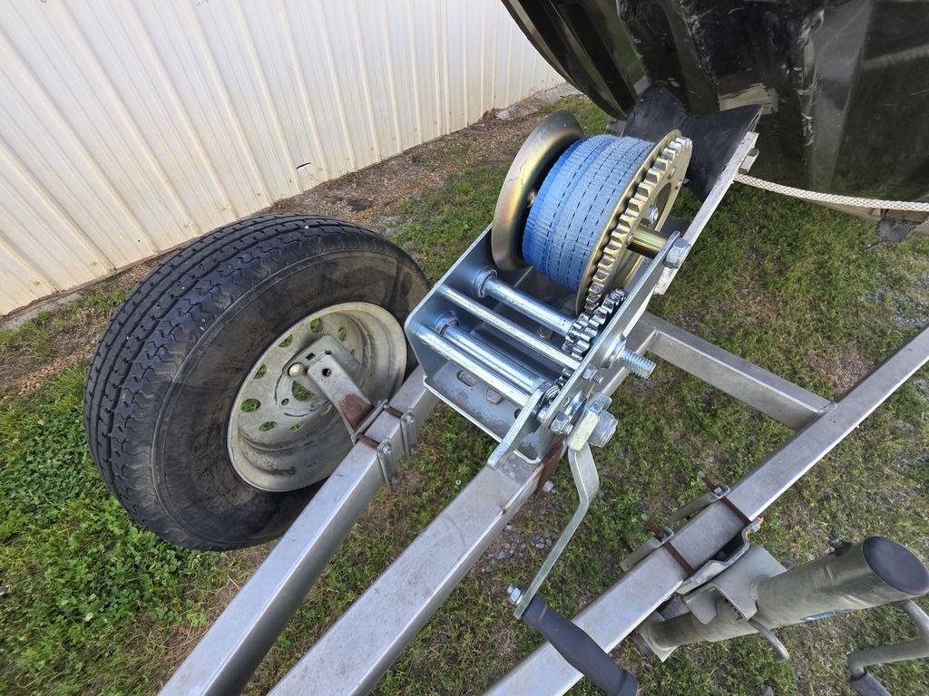 Trailer winch and wheel of 2008 Xpress XP16PF Stick-Steer boat on grass.