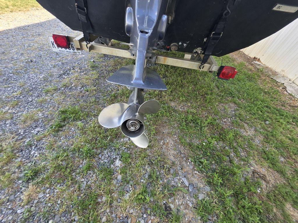 2008 Xpress XP16PF Stick-Steer boat propeller on trailer, parked on gravel and grass.