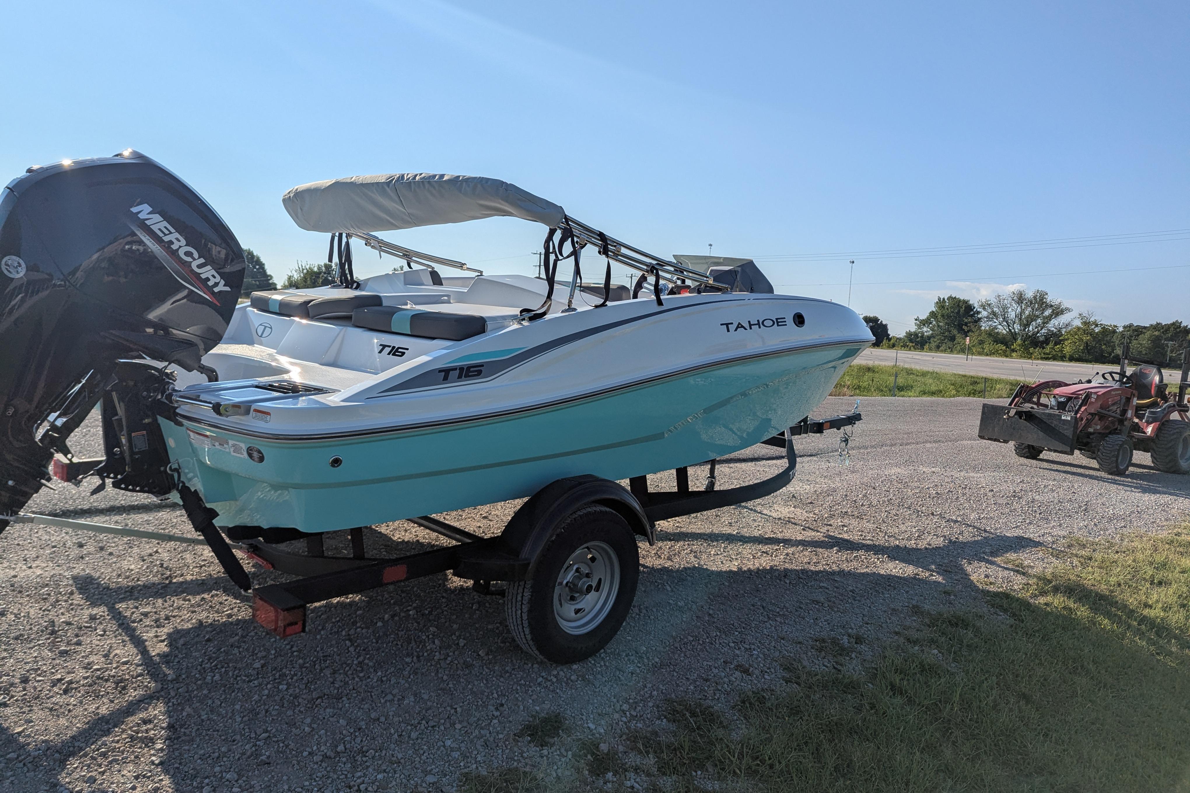 2026 Tahoe T16 boat on trailer with Mercury outboard motor, parked outdoors.