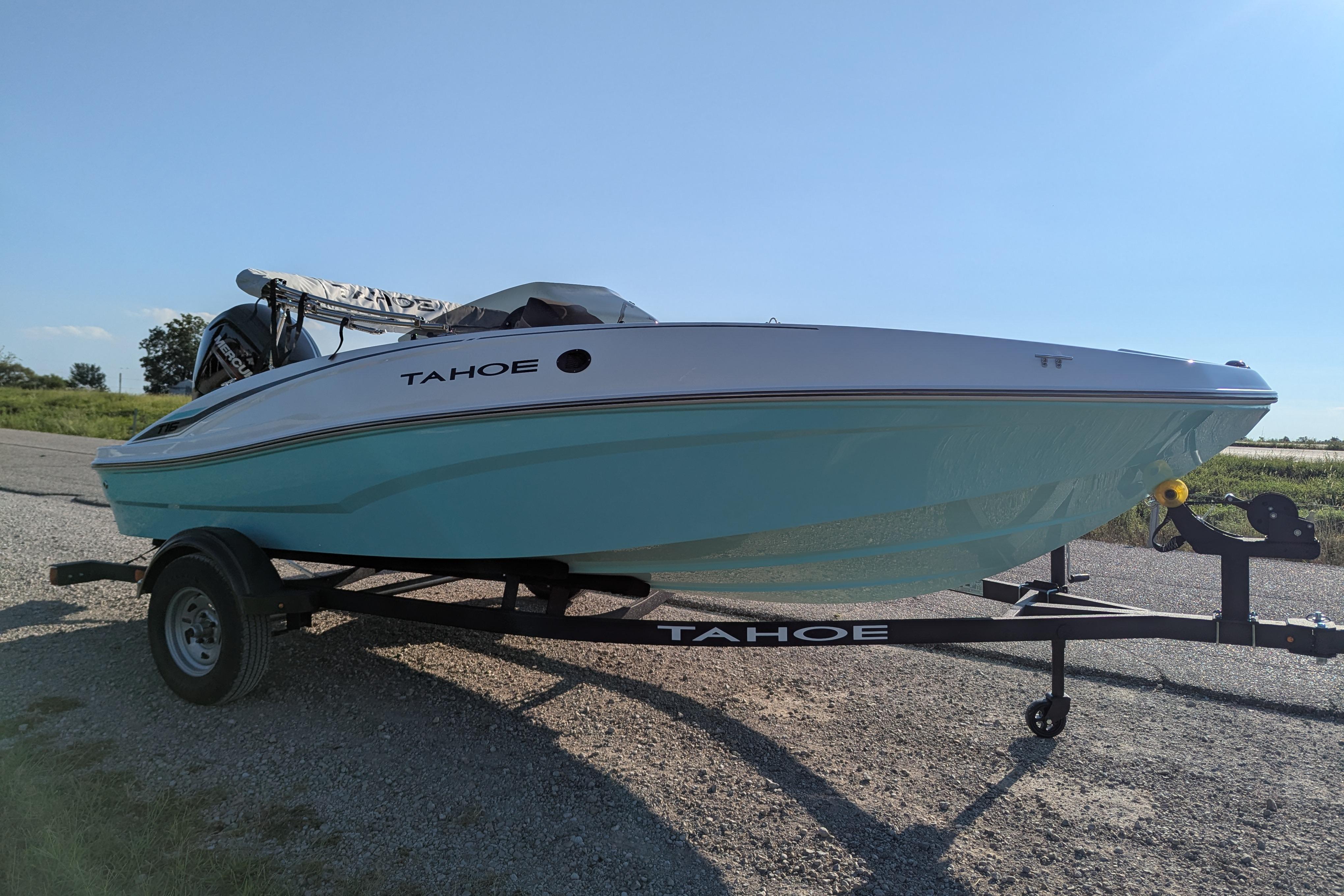 2026 Tahoe T16 boat on trailer, parked outdoors under clear blue sky.