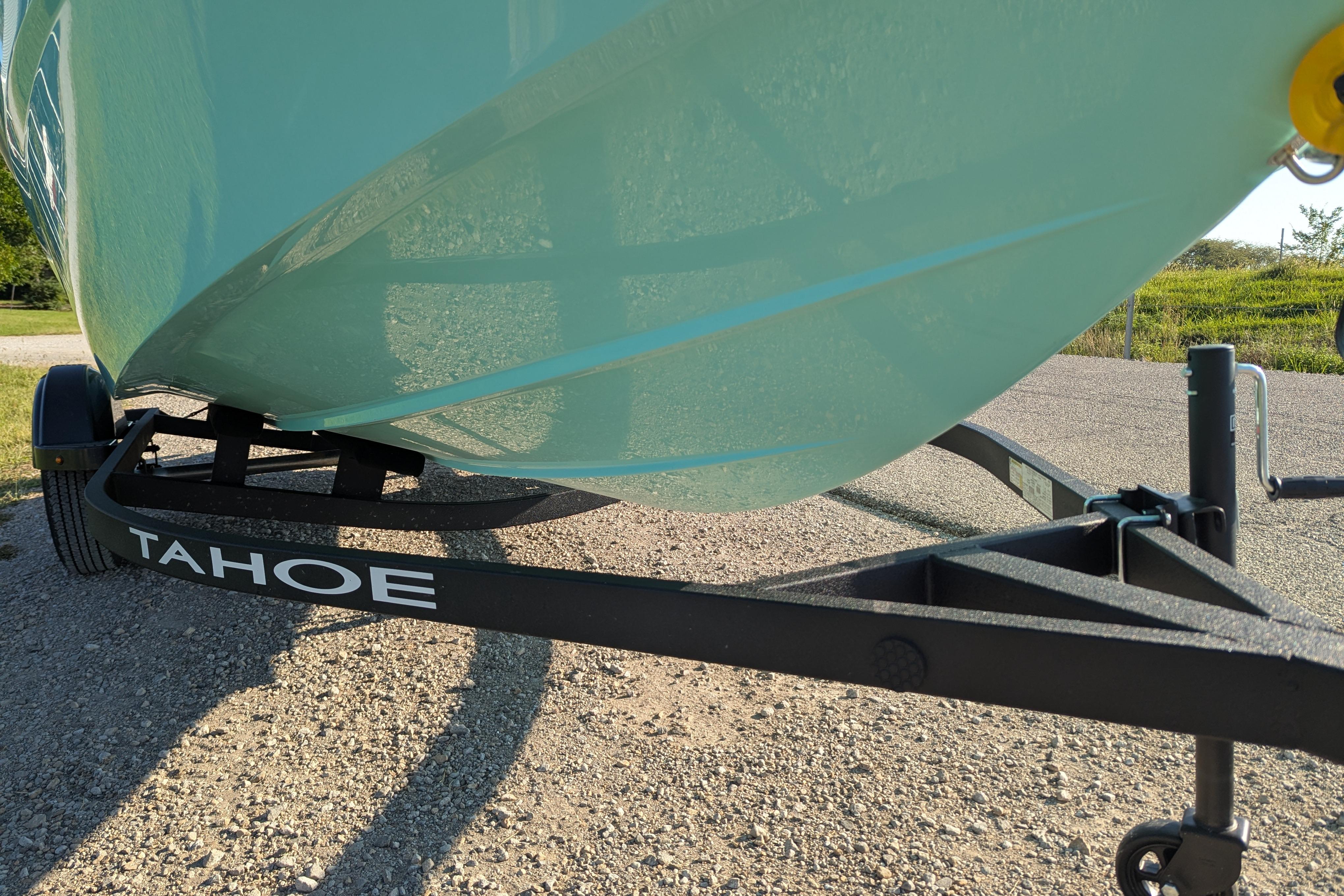 2026 Tahoe T16 boat on trailer, parked on gravel road.