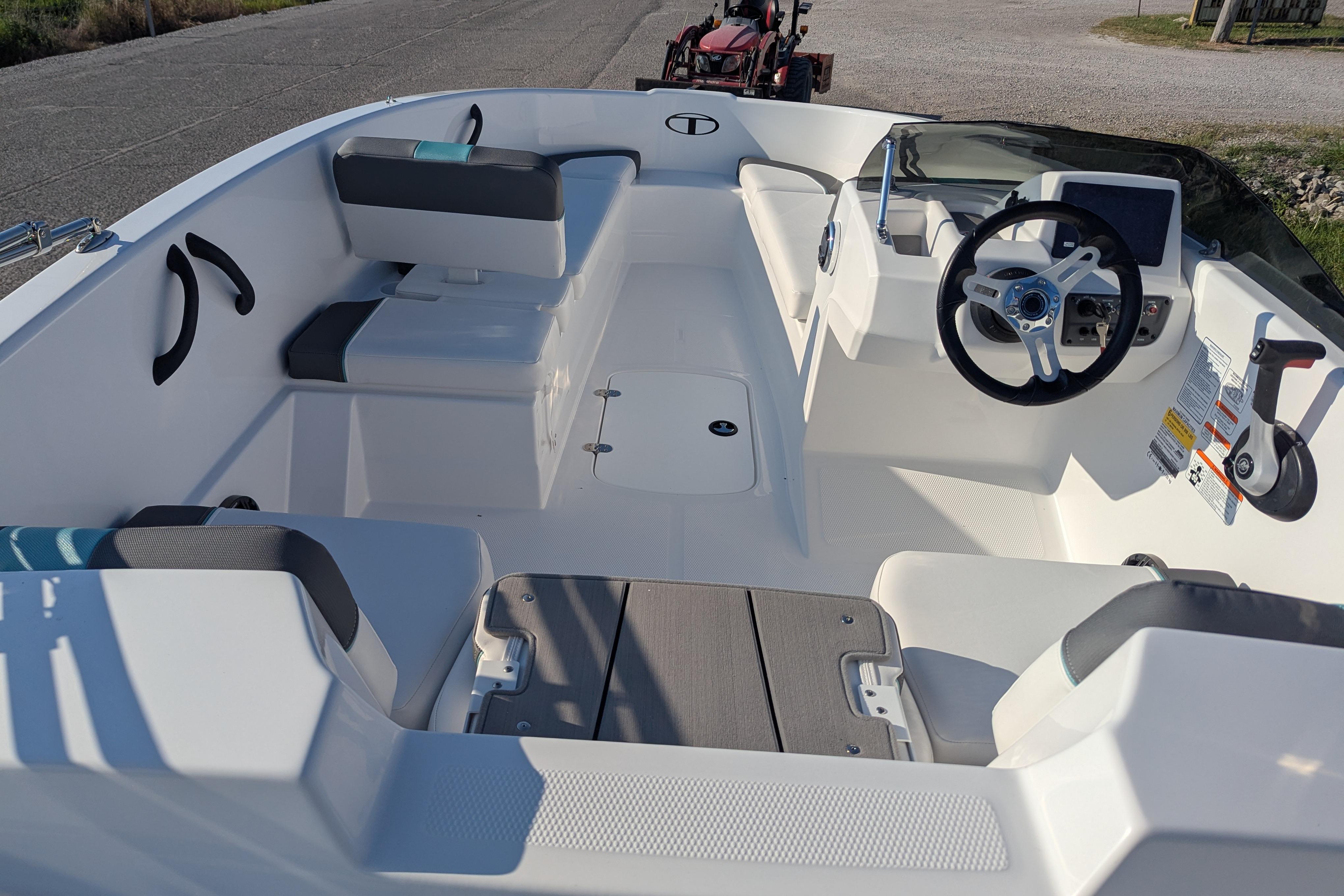 2026 Tahoe T16 boat interior with steering wheel, seating, and control panel.