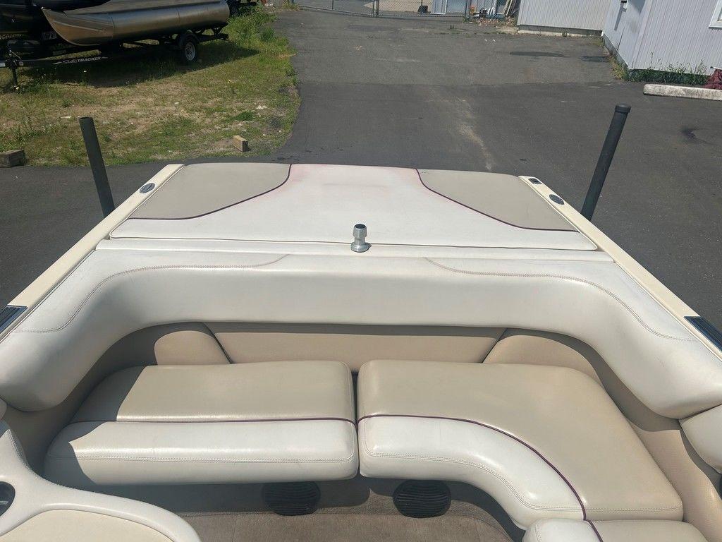 1999 Malibu Sunsetter VLX boat interior with beige seating and open deck.