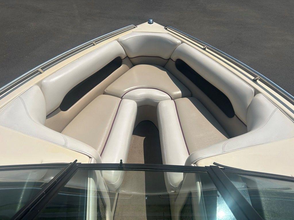 1999 Malibu Sunsetter VLX boat interior with beige seating and sleek design.