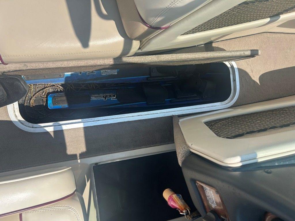 1999 Malibu Sunsetter VLX interior storage compartment with equipment.