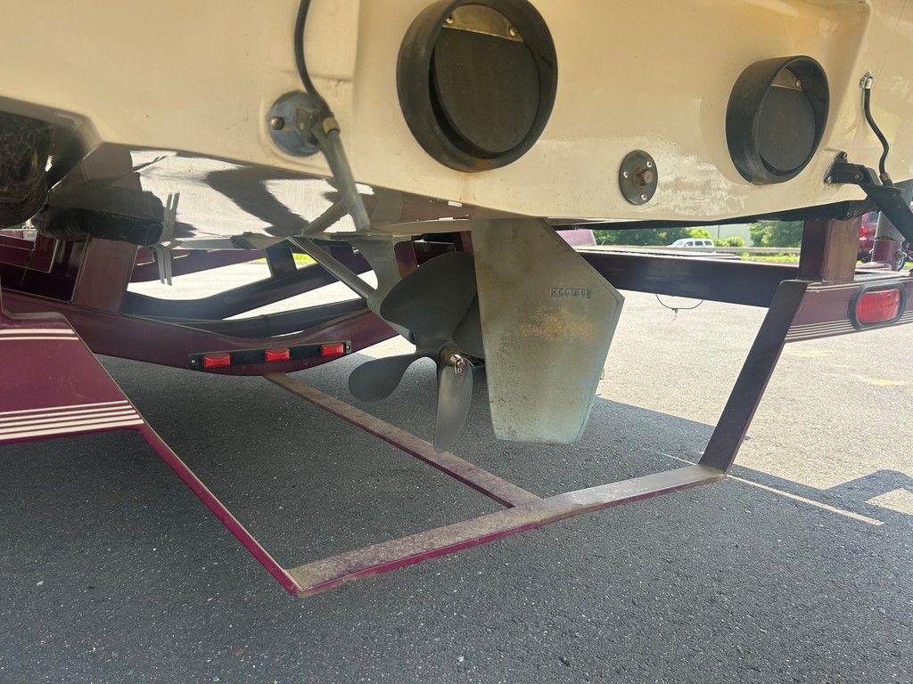 1999 Malibu Sunsetter VLX boat propeller and rudder on a trailer.