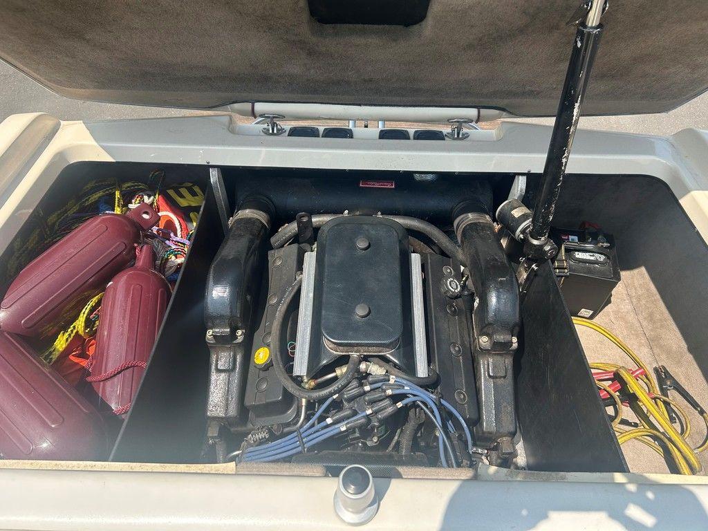 1999 Malibu Sunsetter VLX engine compartment with accessories and wiring visible.
